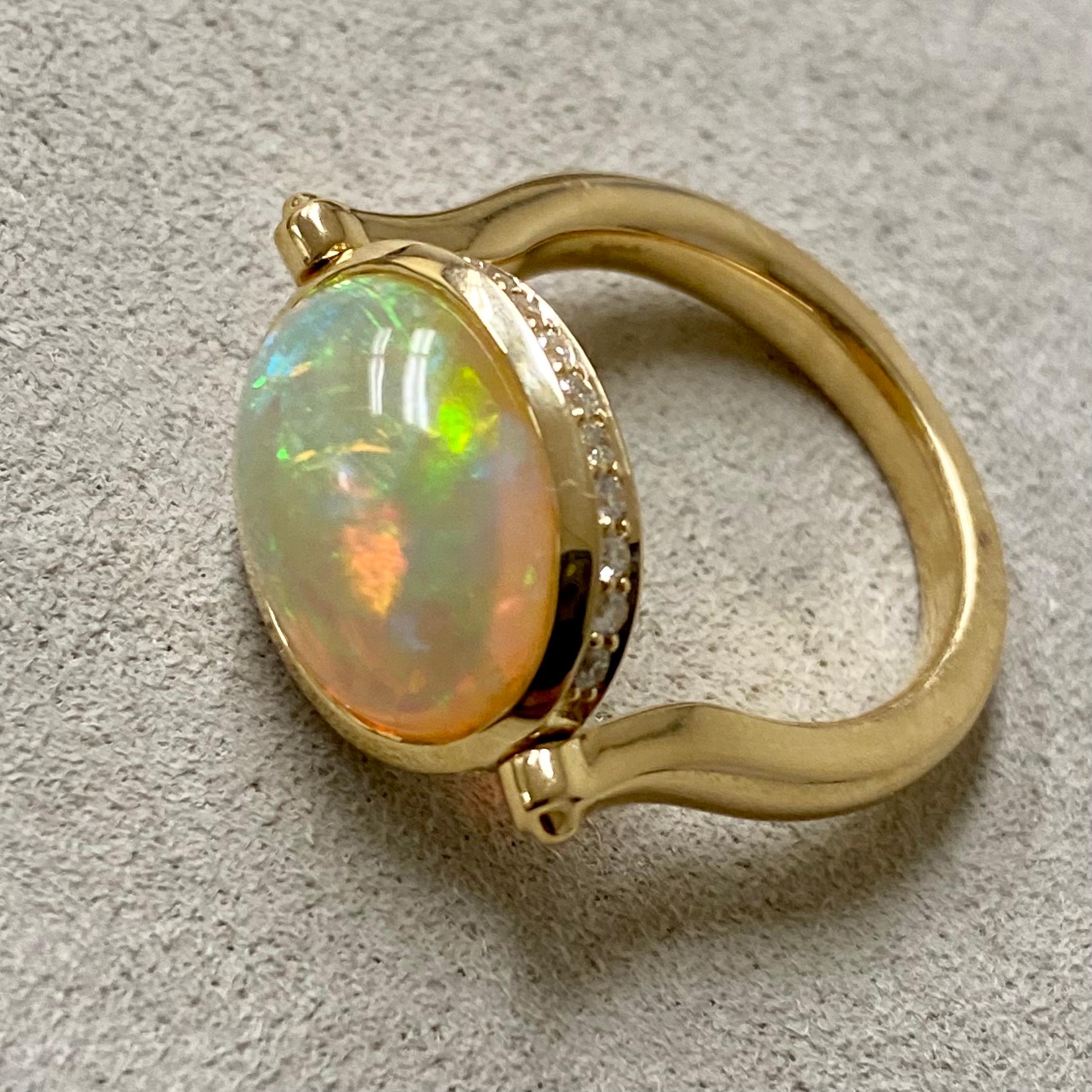 Created in 18 karat yellow gold
Ethiopian Opal 4 carats approx.
Diamonds 0.30 carat approx.
Ring size US 6.5, can be sized as per request
Swivel mechanism
One of a kind

Stunningly crafted in 18 karat yellow gold, this one-of-a-kind ring features an