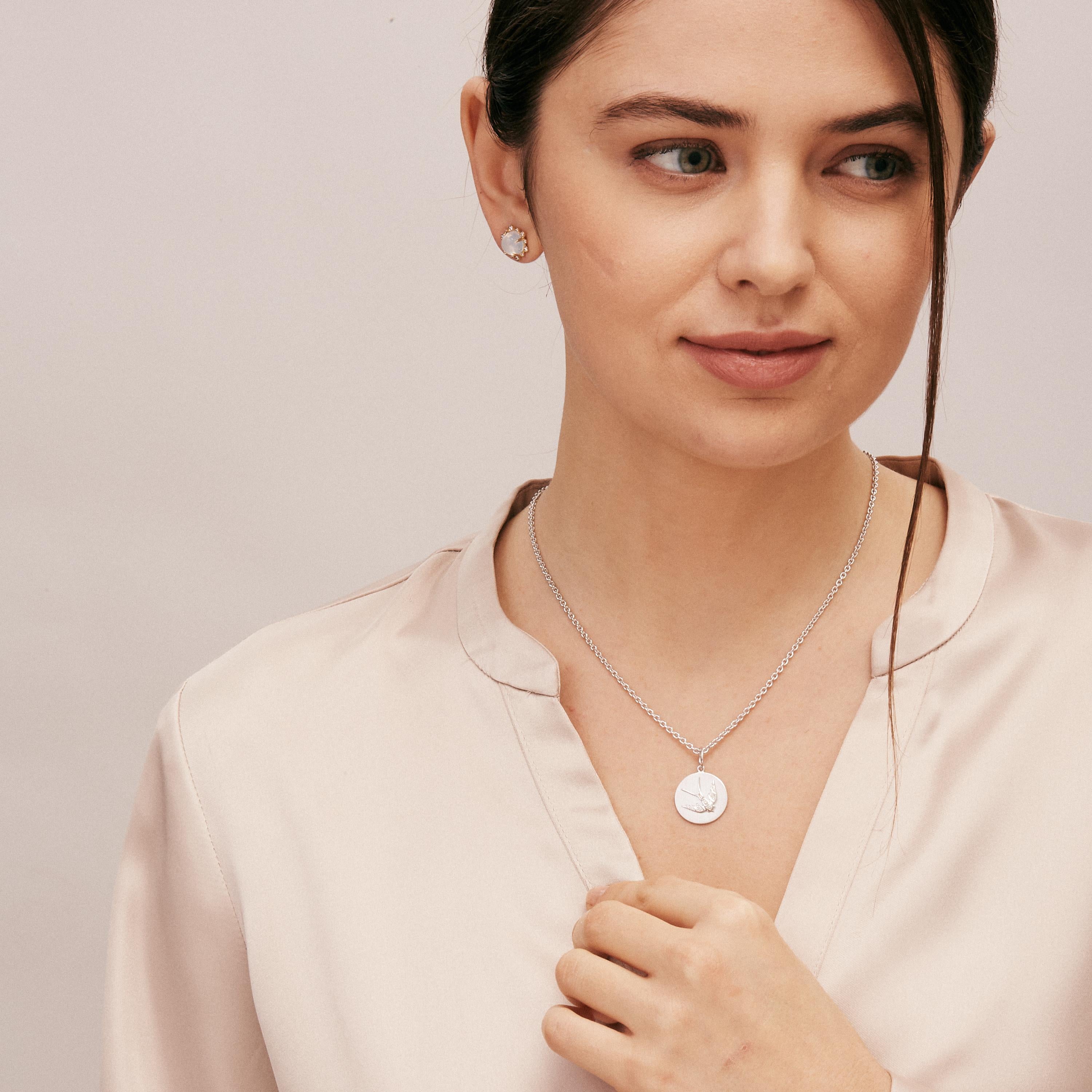 Created in 925 sterling silver
Diamonds 0.09 carat approx.
Satin finish background
Limited edition
Chain sold separately

Sculpted with 925 sterling silver, these gems sparkle with ~0.09 ct of diamonds! A satin backdrop adds a luxe touch to this