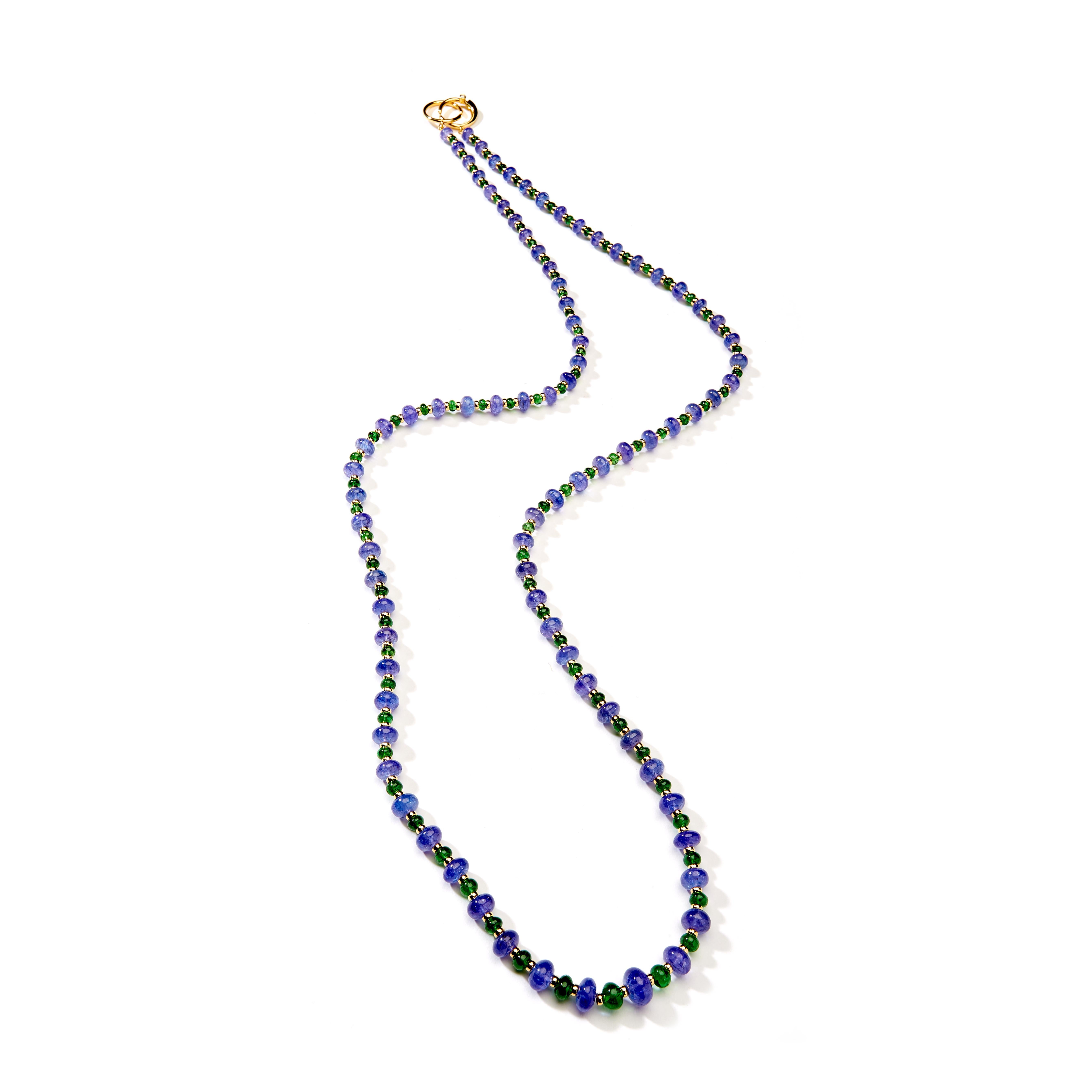 Created in 18 karat yellow gold
36 inch length
Tanzanite 300 carats approx.
Tsavorite 48 carats approx.
18kyg roundels 
18kyg ring clasp with diamond
Strung on silk
Limited edition

Fashioned from 18 karat yellow gold, this 36-inch necklace exudes