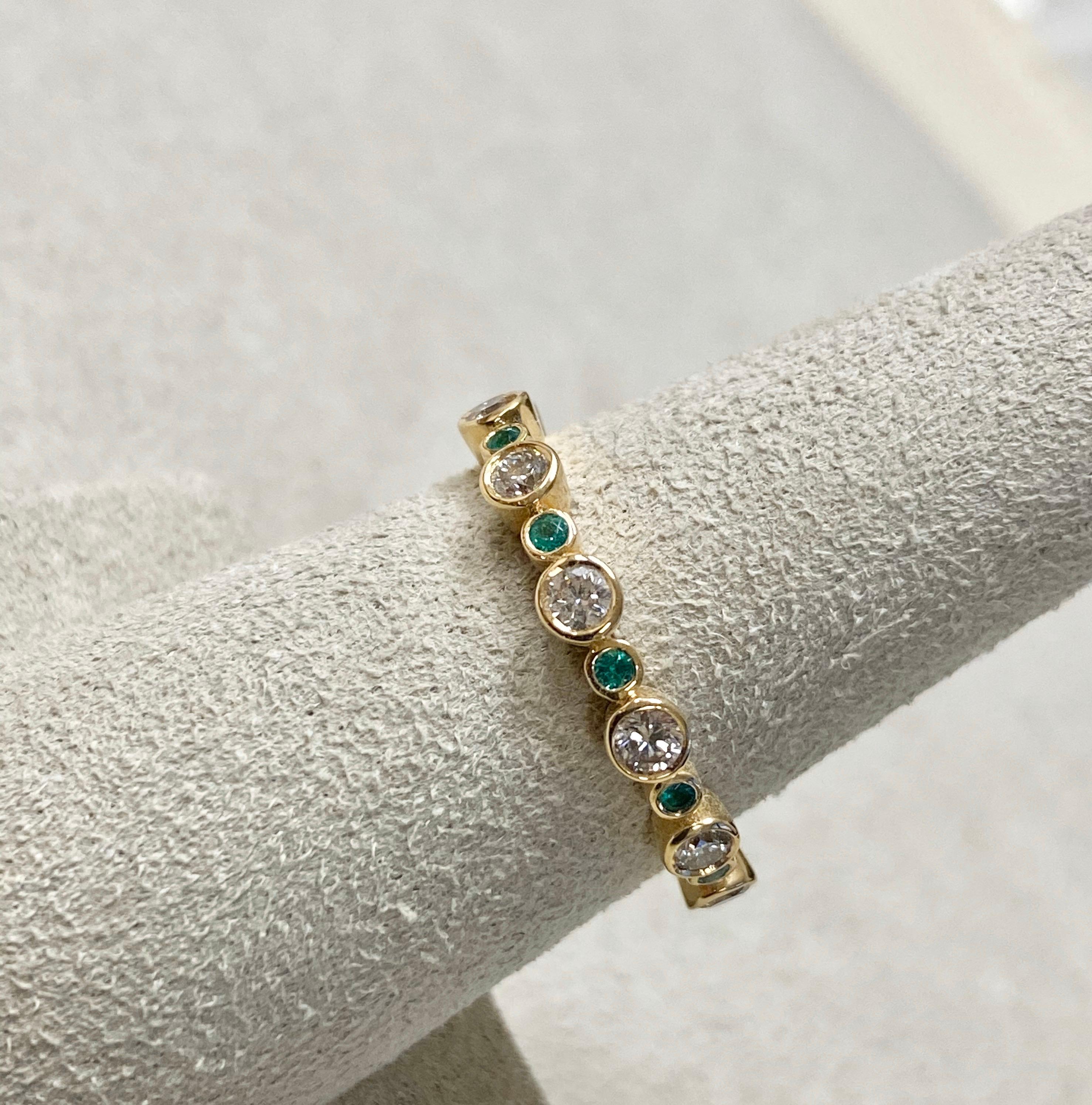 Contemporary Syna Yellow Gold Band with Emeralds and Diamonds For Sale
