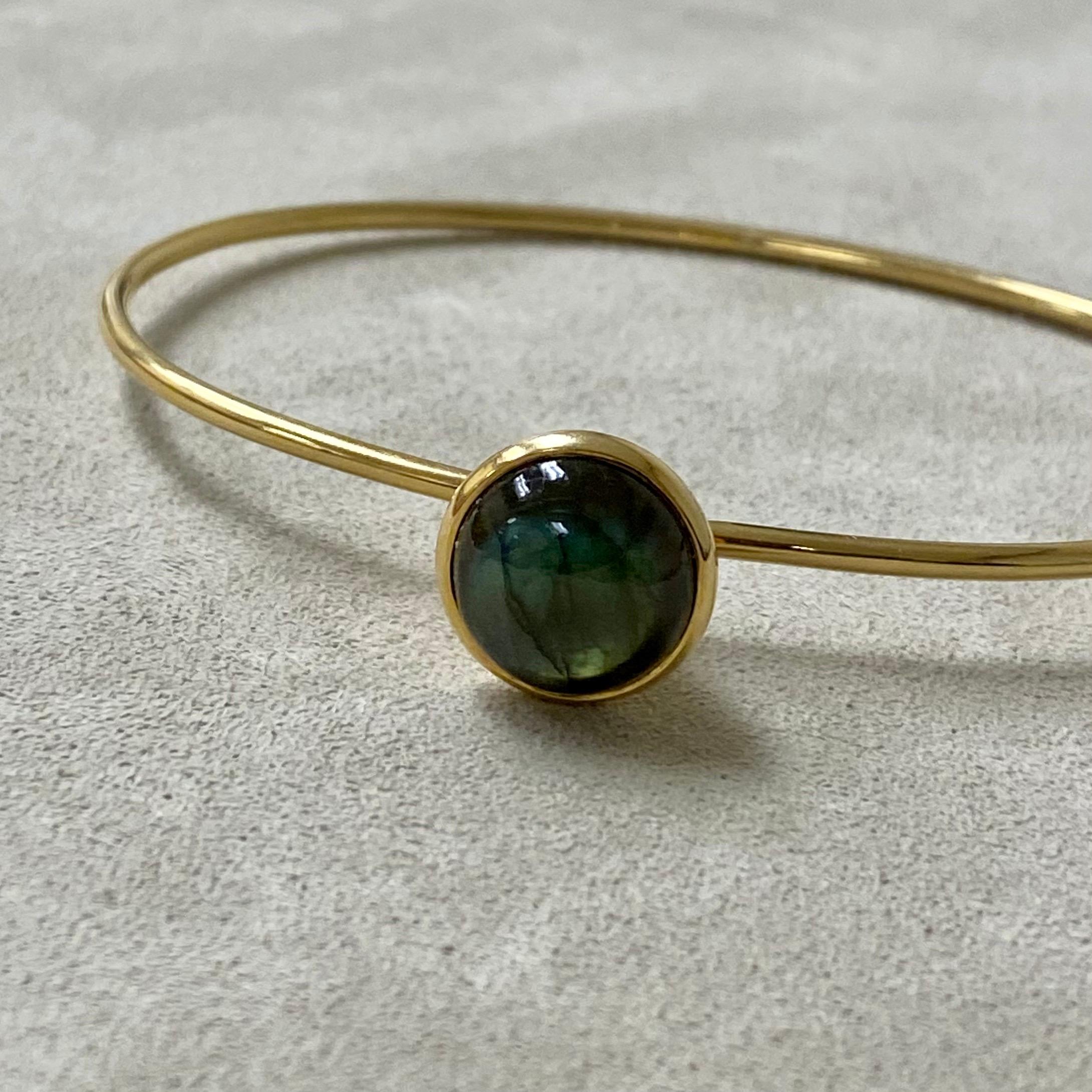 Created in 18 karat yellow gold
Labradorite 7.5 carats approx.
Openable oval bracelet
Hidden mechanism to open under bauble

Exquisitely crafted in 18 karat yellow gold, this captivating bracelet features a luminous labradorite stone weighing in at