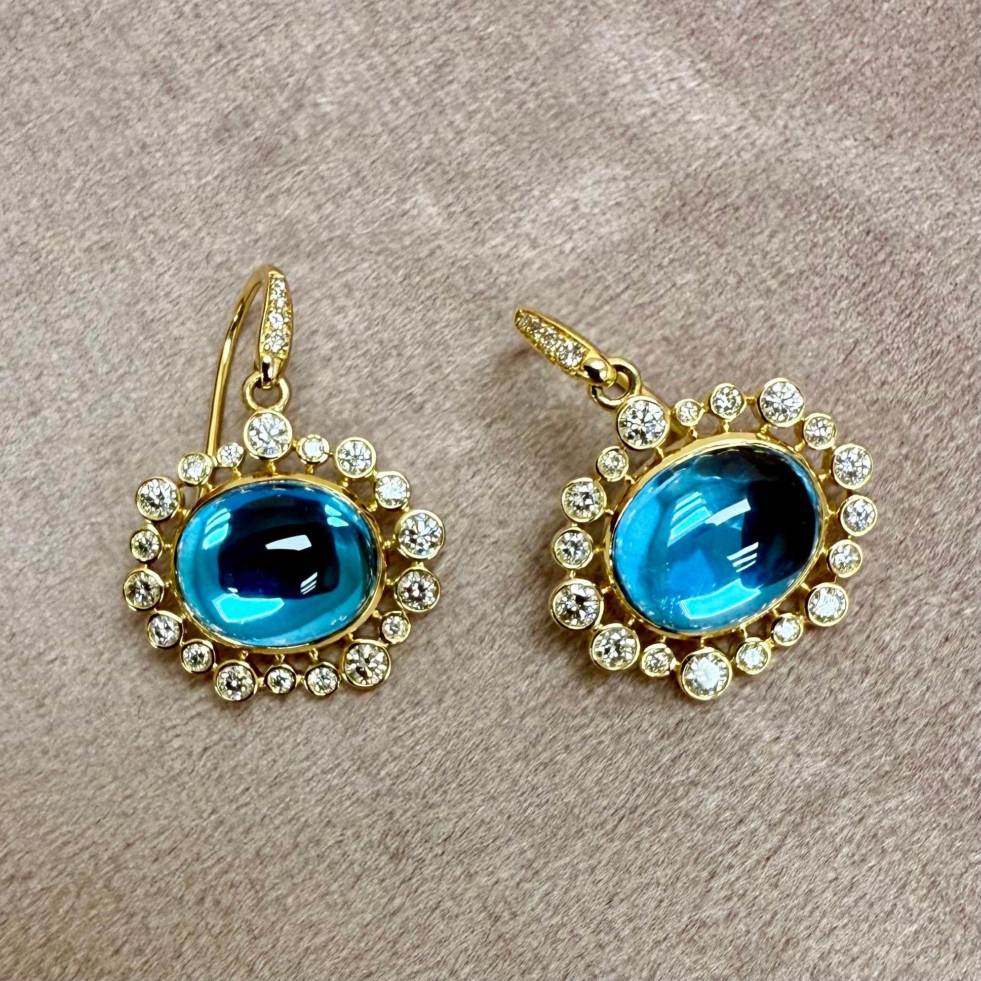Created in 18 karat yellow gold
Blue Topaz 10 carats approx.
Diamonds 0.80 carat approx.
French wire for pierced ears
Limited Edition


These Cosmic Oval Gemstone Cluster Diamond Earrings are expertly crafted with 18 karat yellow gold and feature