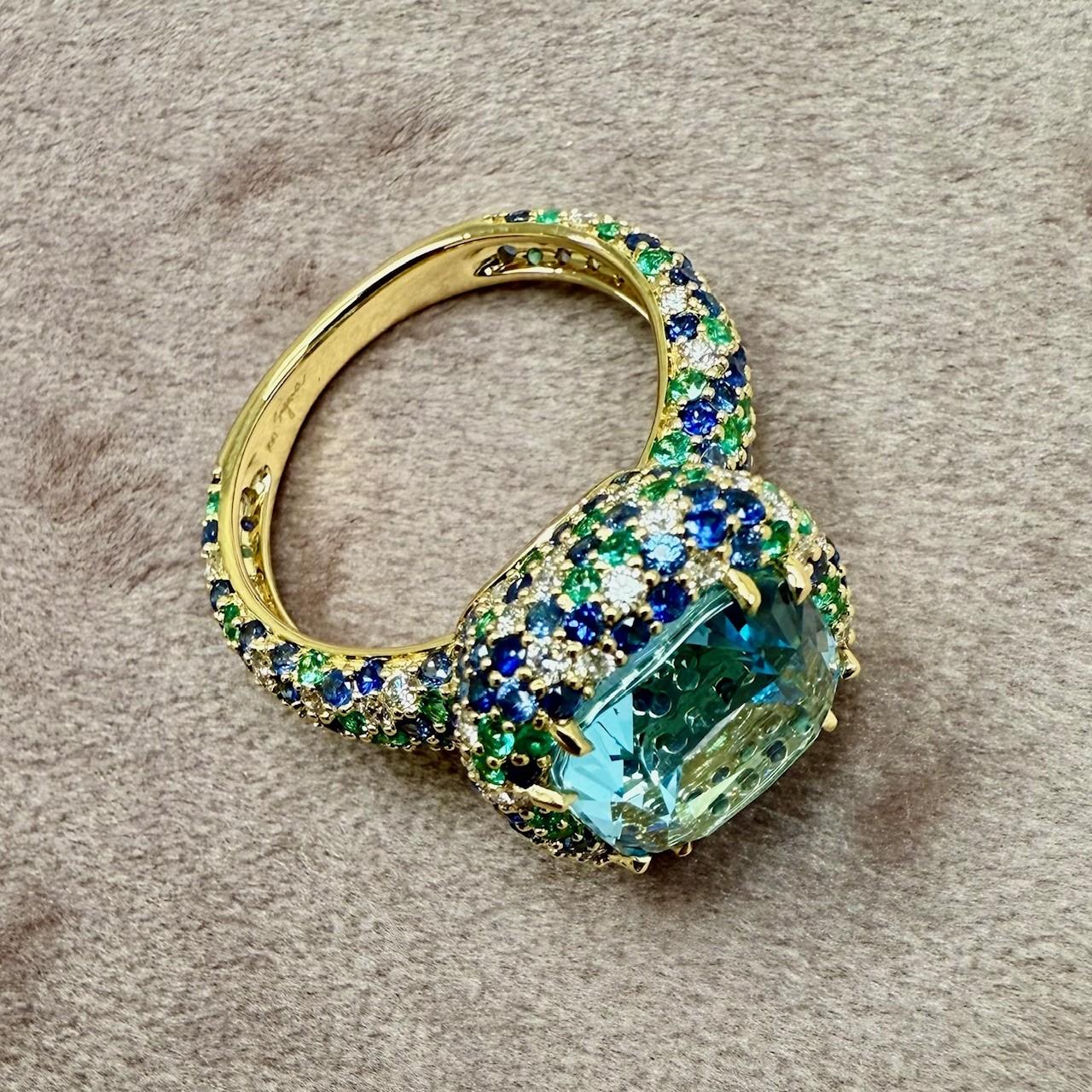 Created in 18 karat yellow gold
Blue Topaz 5.50 carats approx.
Sapphires 1.45 carats approx.
Emeralds 0.54 carat approx.
Diamonds 0.58 carat approx.                          
Ring size US 7

Exquisitely crafted from 18 karat yellow gold, this lavish