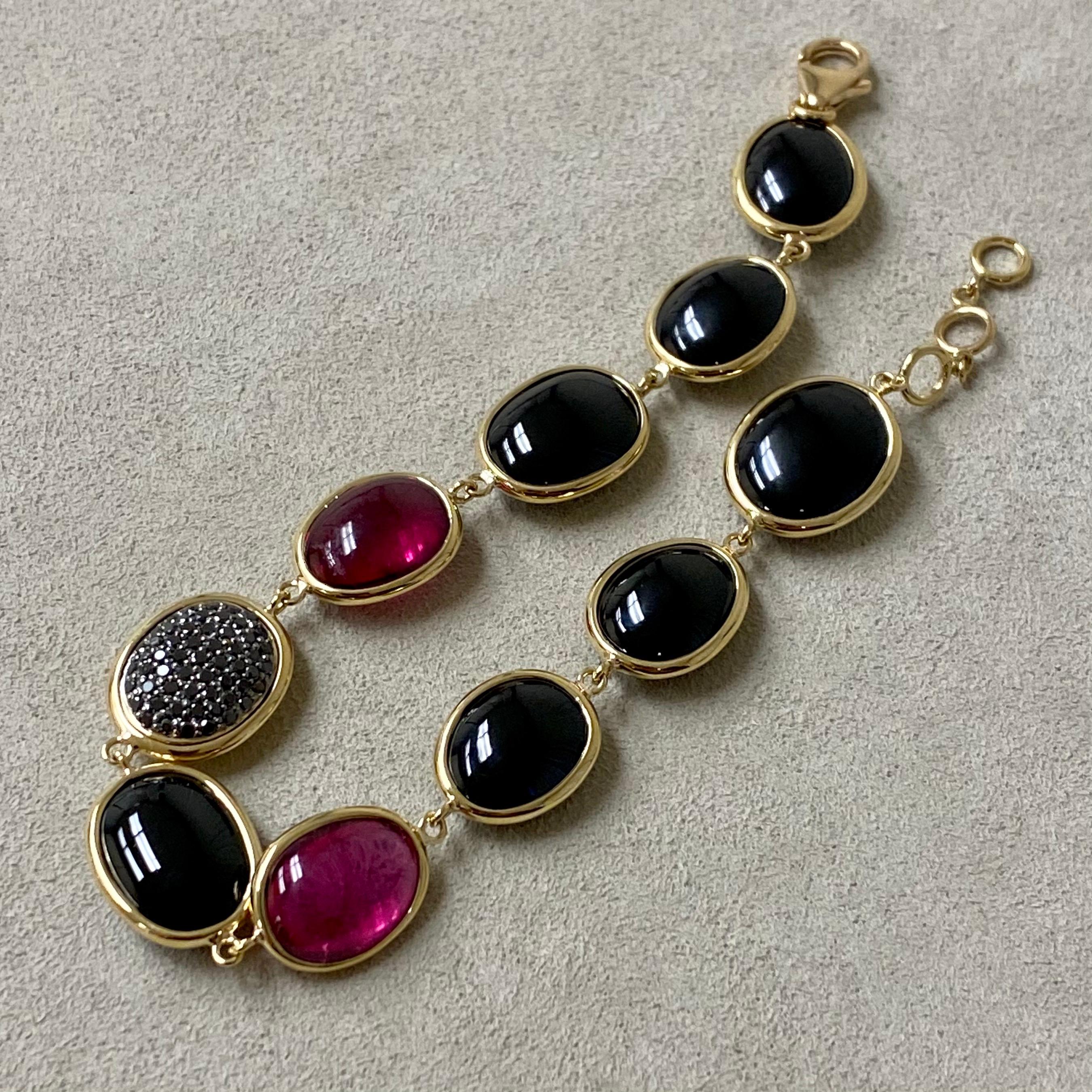 Created in 18 karat yellow gold
Black Diamonds 0.40 carats approx.
Rubellite 15 carats approx.
Black Spinel 65 carats approx.
8 inches with lobster clasp

This stunning bracelet is crafted from 18 karat yellow gold and accented with 0.40 carats of