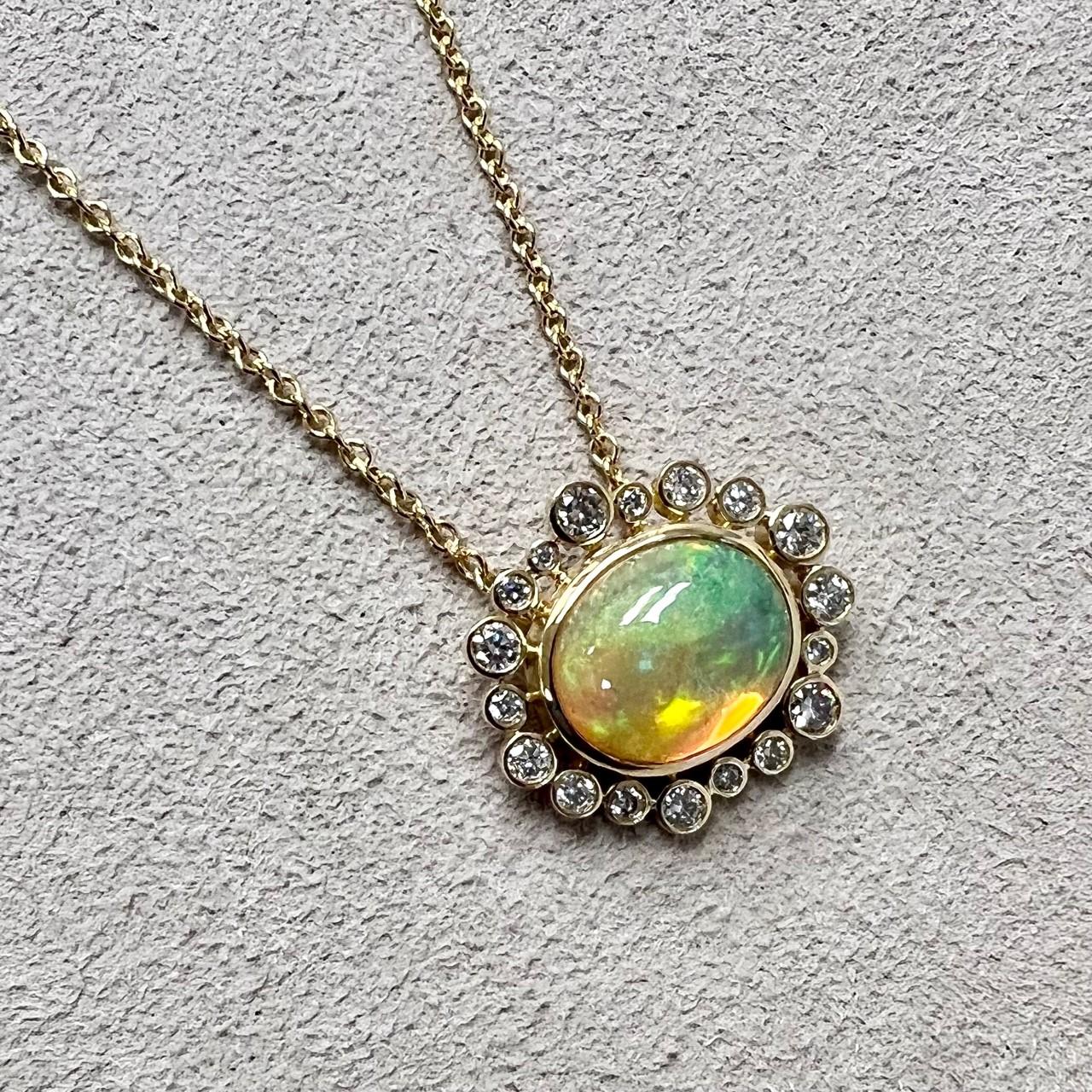 Created in 18 karat yellow gold
Ethiopian opal 2.80 carats approx.
Diamonds 0.40 carat approx.
18 inch chain with loops at 16th and 17th inch
Lobster lock

A treat for your neck, this 18 karat yellow gold necklace showcases a stunning Ethiopian