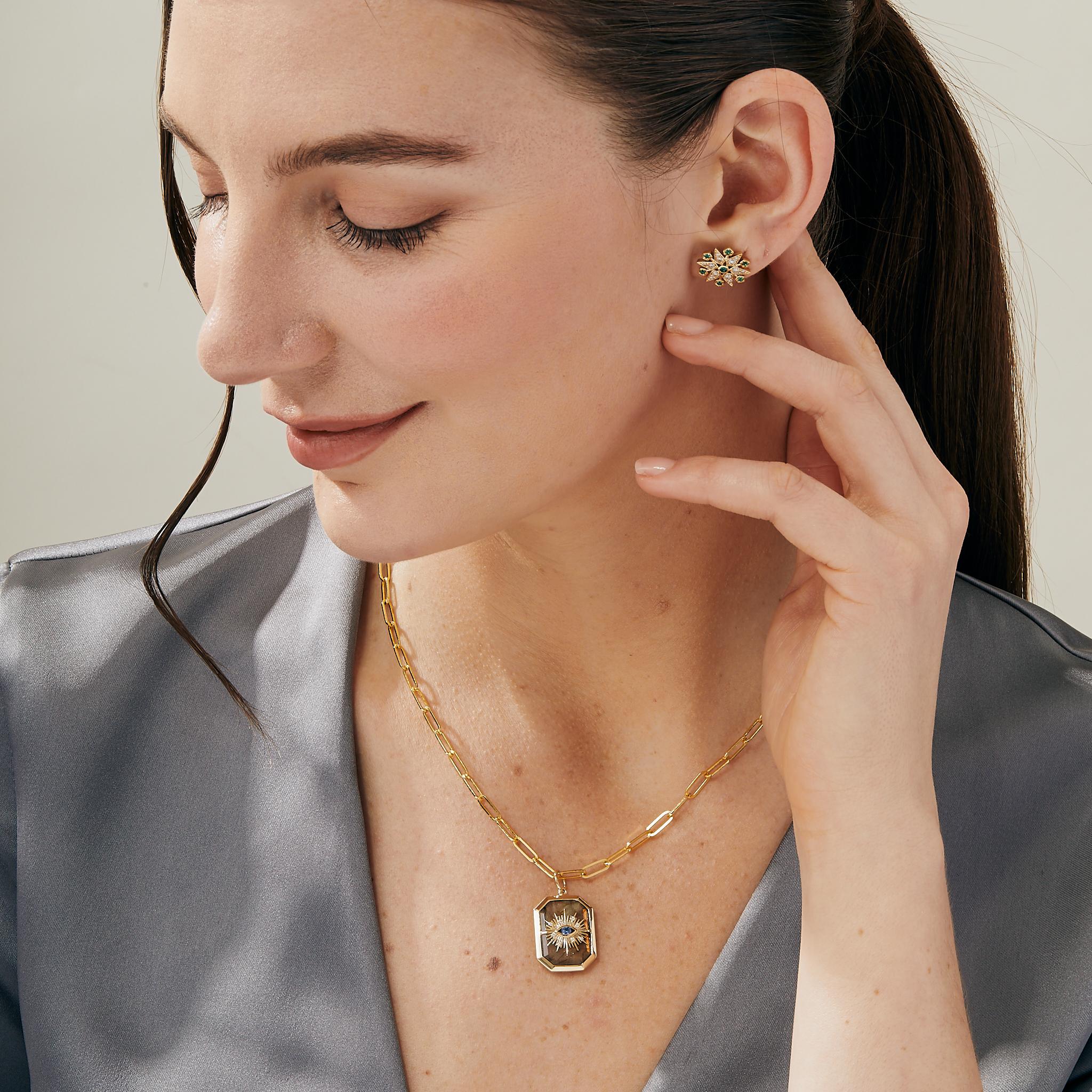 Created in 18 karat yellow gold
Labradorite 12.50 carats approx.
Blue sapphire 0.10 carat approx.
Diamonds 0.03 carat approx.
Chain sold separately
Limited Edition

Crafted from 18 karat yellow gold, this luxurious limited-edition pendant features