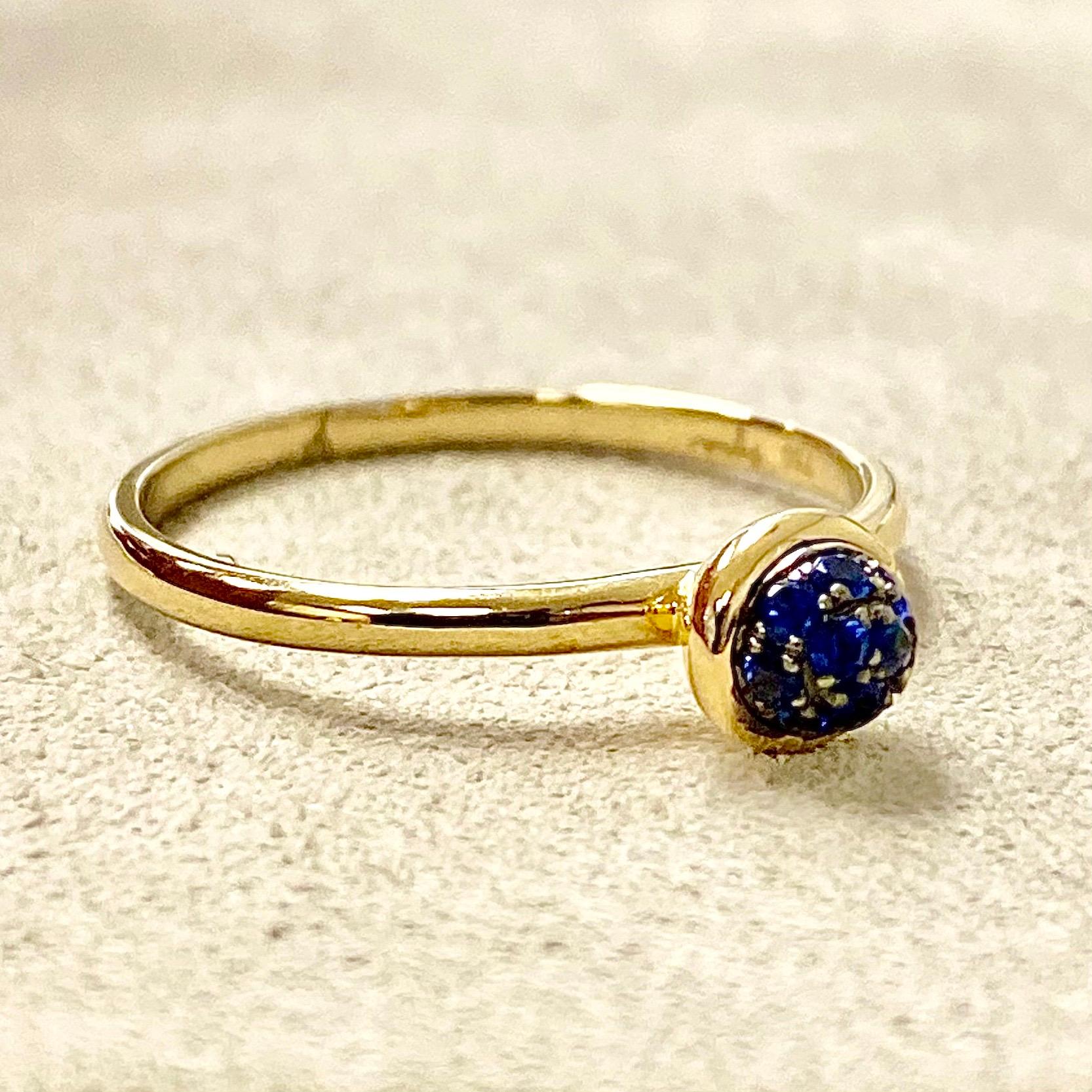 Created in 18 karat yellow gold
Blue sapphires 0.10 carat approx.
Blue sapphire pave ring 5 mm diameter approx.
Ring size US 6.5, can be sized upon request.

Crafted in luminous 18K yellow gold, this ring is distinguished by its sprinkling of 0.10