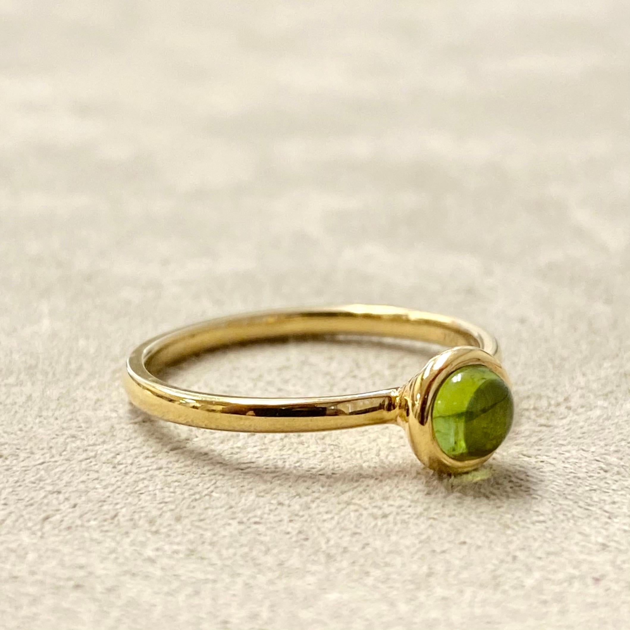 Created in 18 karat yellow gold
Peridot cabochon
Ring size US 6.5, can be sized upon request.

Masterfully wrought in 18 karat yellow gold, this ring showcases a gleaming peridot cabochon and can be resized to any desired ring size on