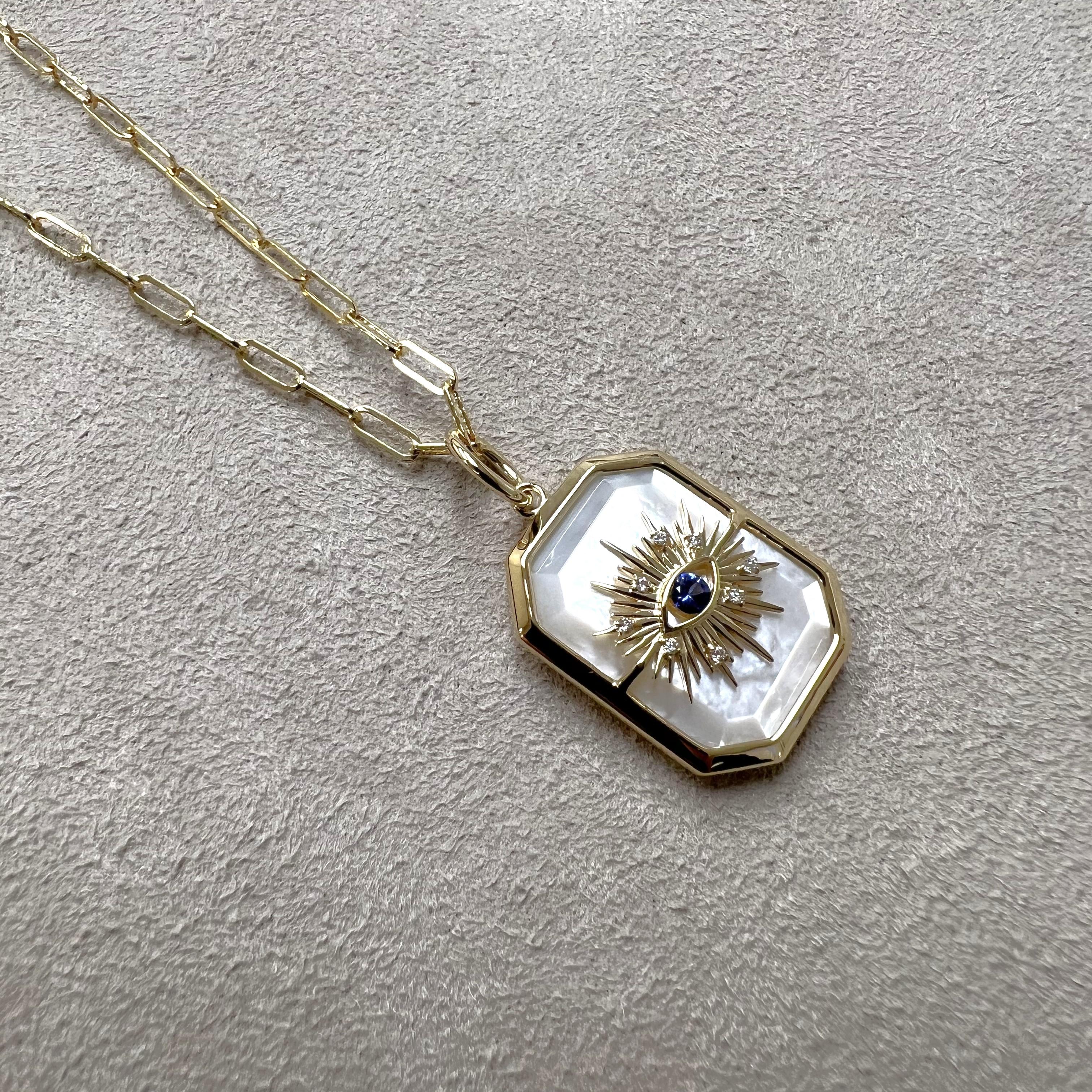 Created in 18 karat yellow gold
Mother of Pearl 12 carats approx.
Blue sapphire 0.10 carat approx.
Diamonds 0.03 carat approx.
Chain sold separately
Limited Edition

Crafted from 18 karat yellow gold, this luxurious limited-edition pendant features