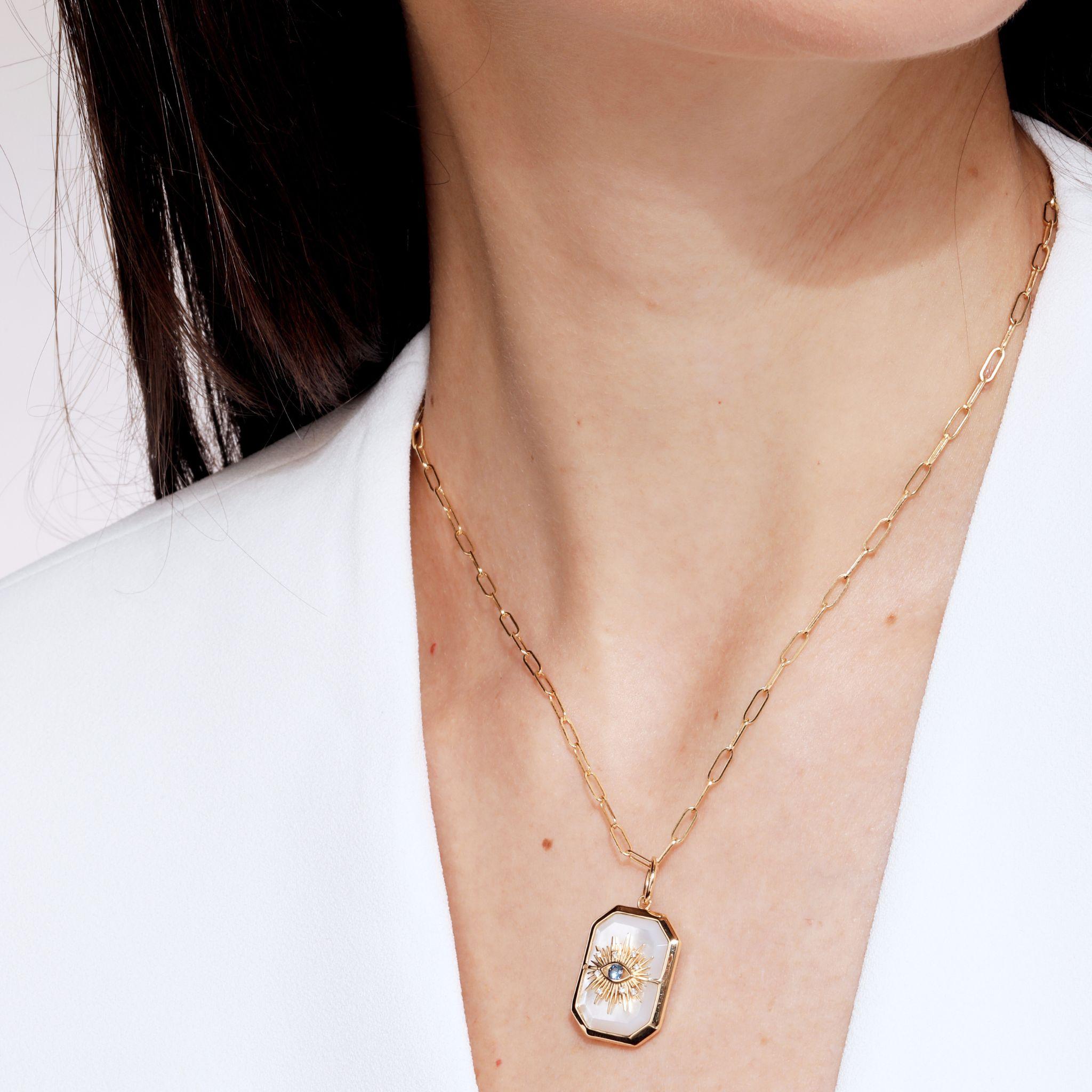 Created in 18 karat yellow gold
Mother of Pearl 12 carats approx.
Blue sapphire 0.10 carat approx.
Diamonds 0.03 carat approx.
Chain sold separately
Limited Edition

Crafted from 18 karat yellow gold, this luxurious limited-edition pendant features