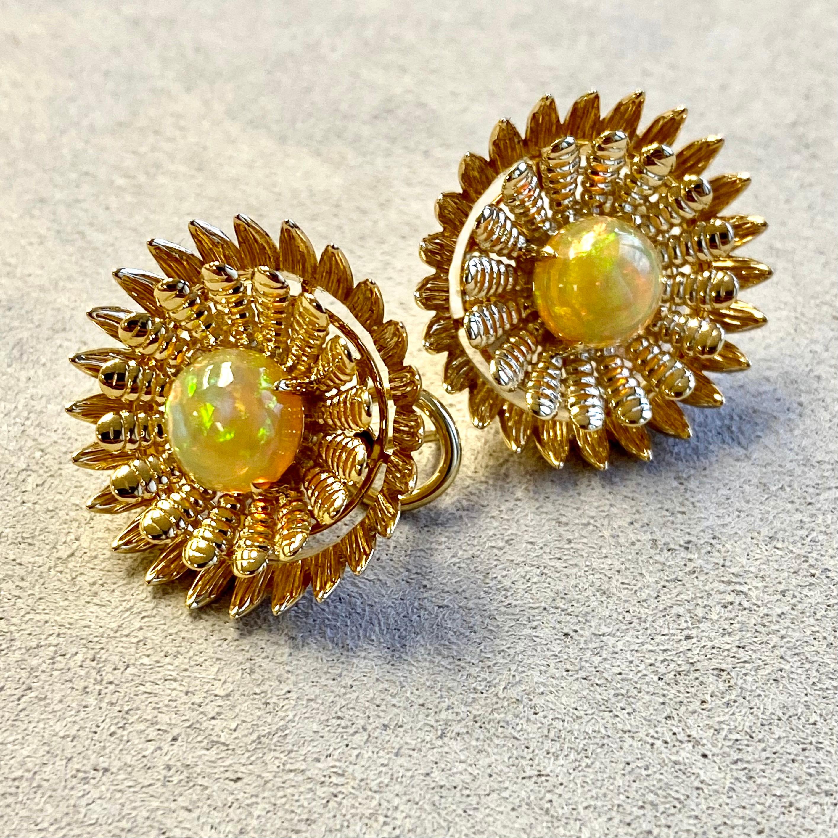 Created in 18 karat yellow gold
Ethiopian Opals 3 carats approx.
Omega Clip-back
Limited edition

These exotic earrings, crafted from lustrous 18 karat yellow gold, feature two precious gemstones: a stunning Candy Blue Topaz and an array of