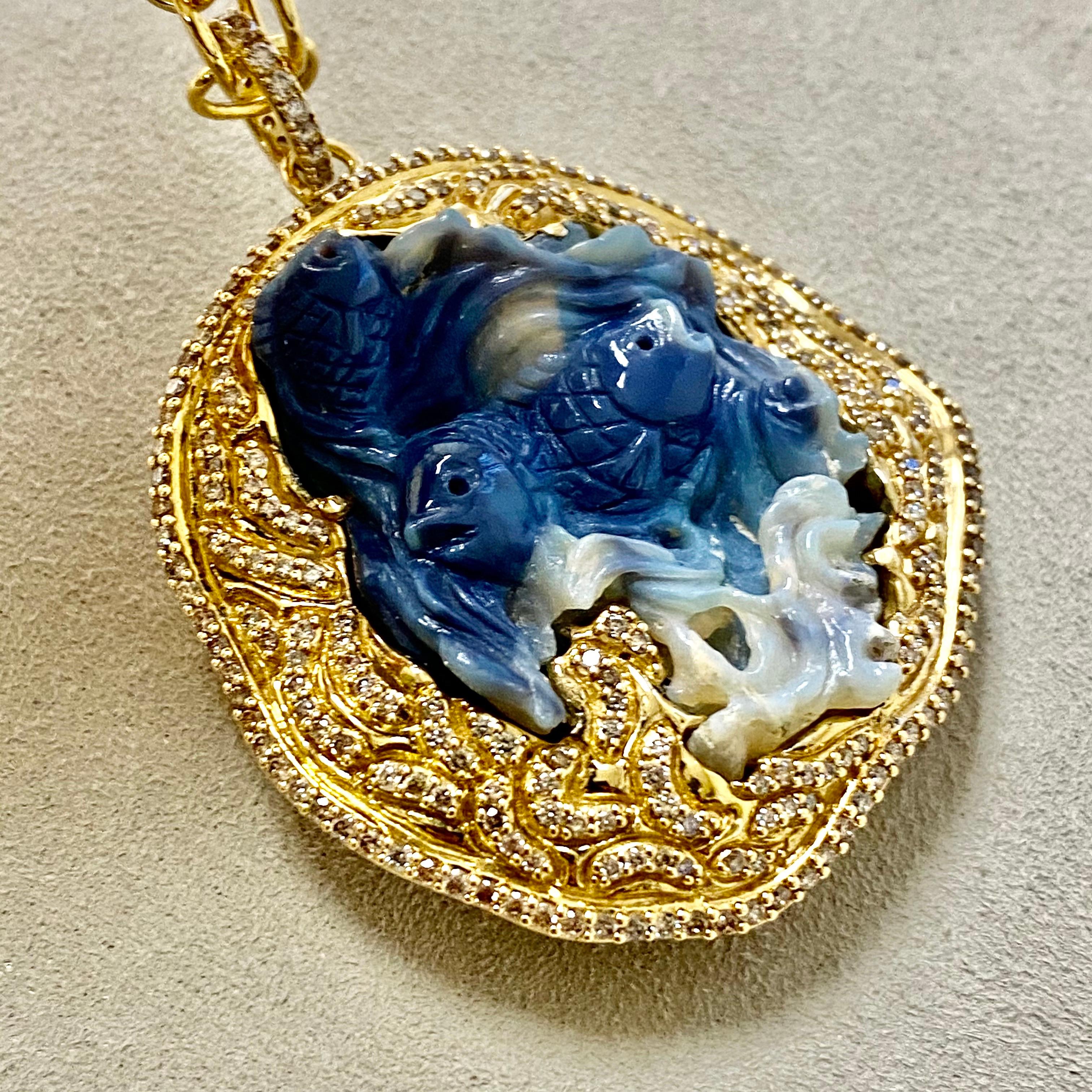 Created in 18 karat yellow gold
Hand carved Opal Fishes in waves 41 carats approx.
Diamonds 2.3 carats approx. 
Chain sold separately
Rare & One of a kind

Crafted in 18 karat yellow gold, this exceptional pendant features two intricately