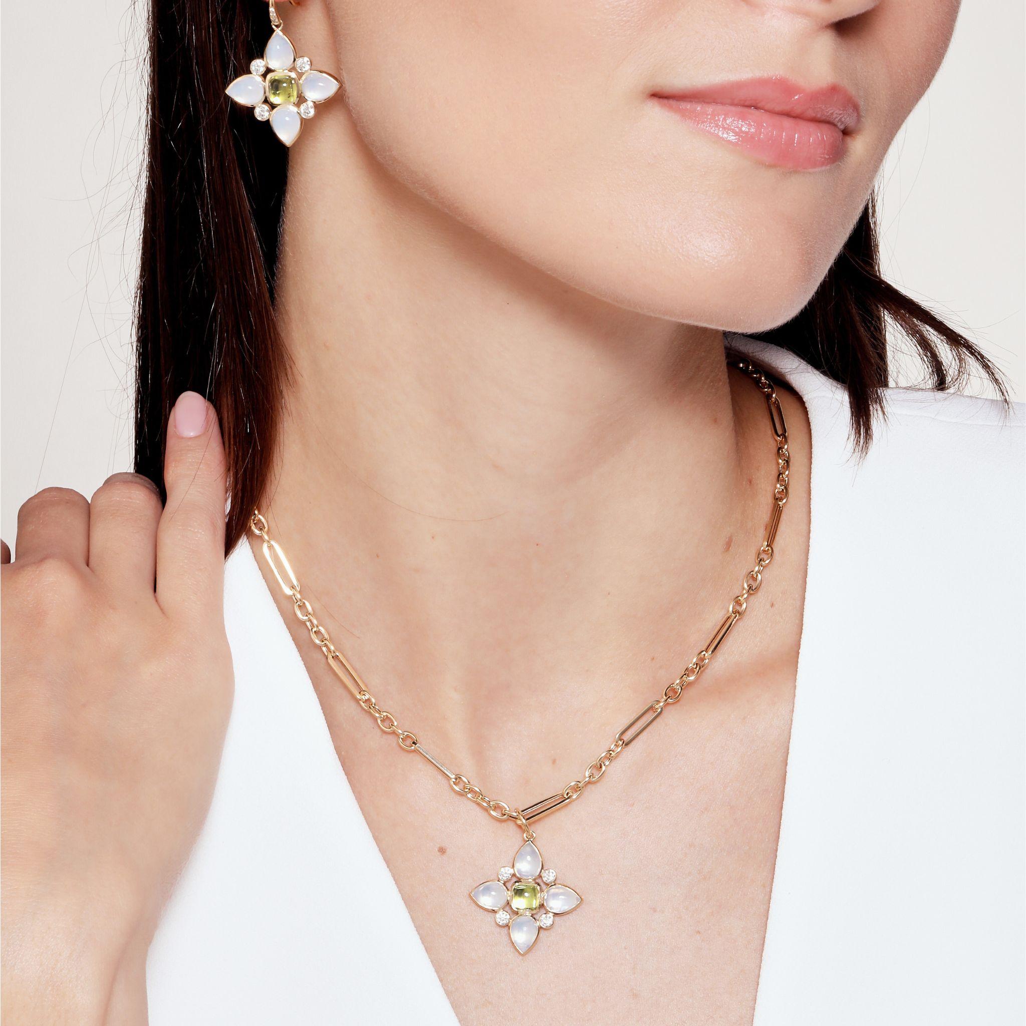 Created in 18 karat yellow gold
Peridot 1.50 carats approx.
Moon Quartz 4.50 carats approx.
Diamonds 0.45 carat approx.
Chain sold separately

Enrobing 18 karat yellow gold, a peridot of 1.50 carats, moon quartz of 4.50 carats, and Diamonds of 0.45