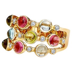 Anillo Syna de Oro Amarillo con Rubelita, Peridoto, Topacio Azul y Diamantes
