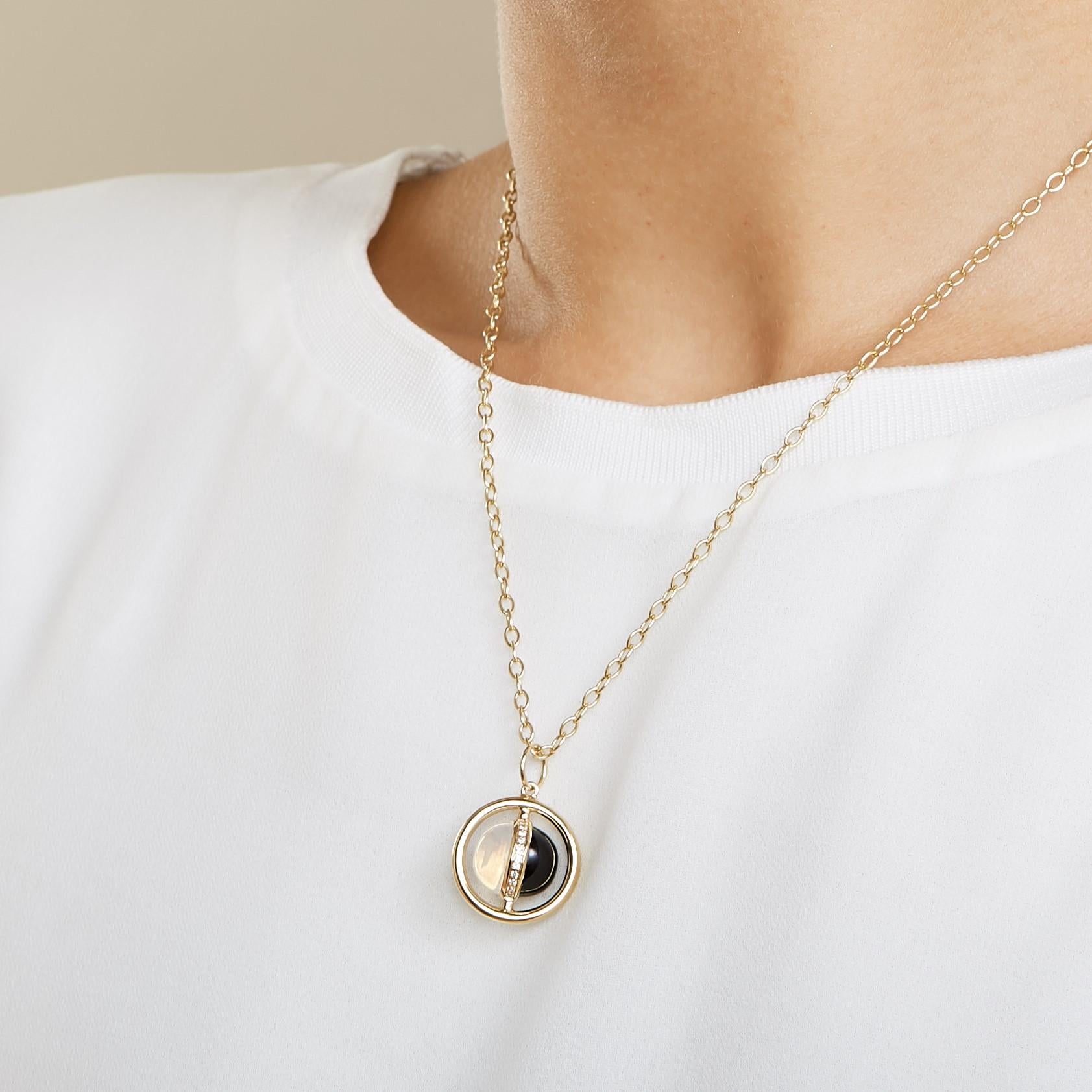 Created in 18kyg
Moon quartz 4 cts apprx
Black onyx 4 cts approx
Diamonds 0.14 ct approx
Day & night reversible pendant
Chain sold separately

Crafted with 18-karat yellow gold, this moon quartz and black onyx pendant captivates with its 4-carat and