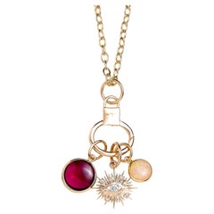 Tre charms in oro giallo Syna con malocchio, pietre e diamanti