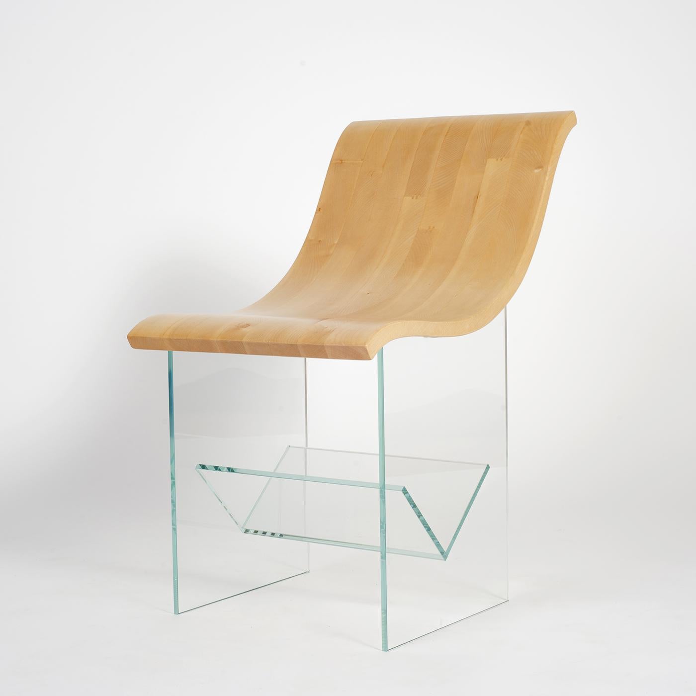 This Classic chair is characterized by exceptional craftsmanship and modern aesthetic balance. The chair frame, made of maple wood with a light grain, effortlessly flows from the curved architectural back to the wide seat and geometric, glass legs.
