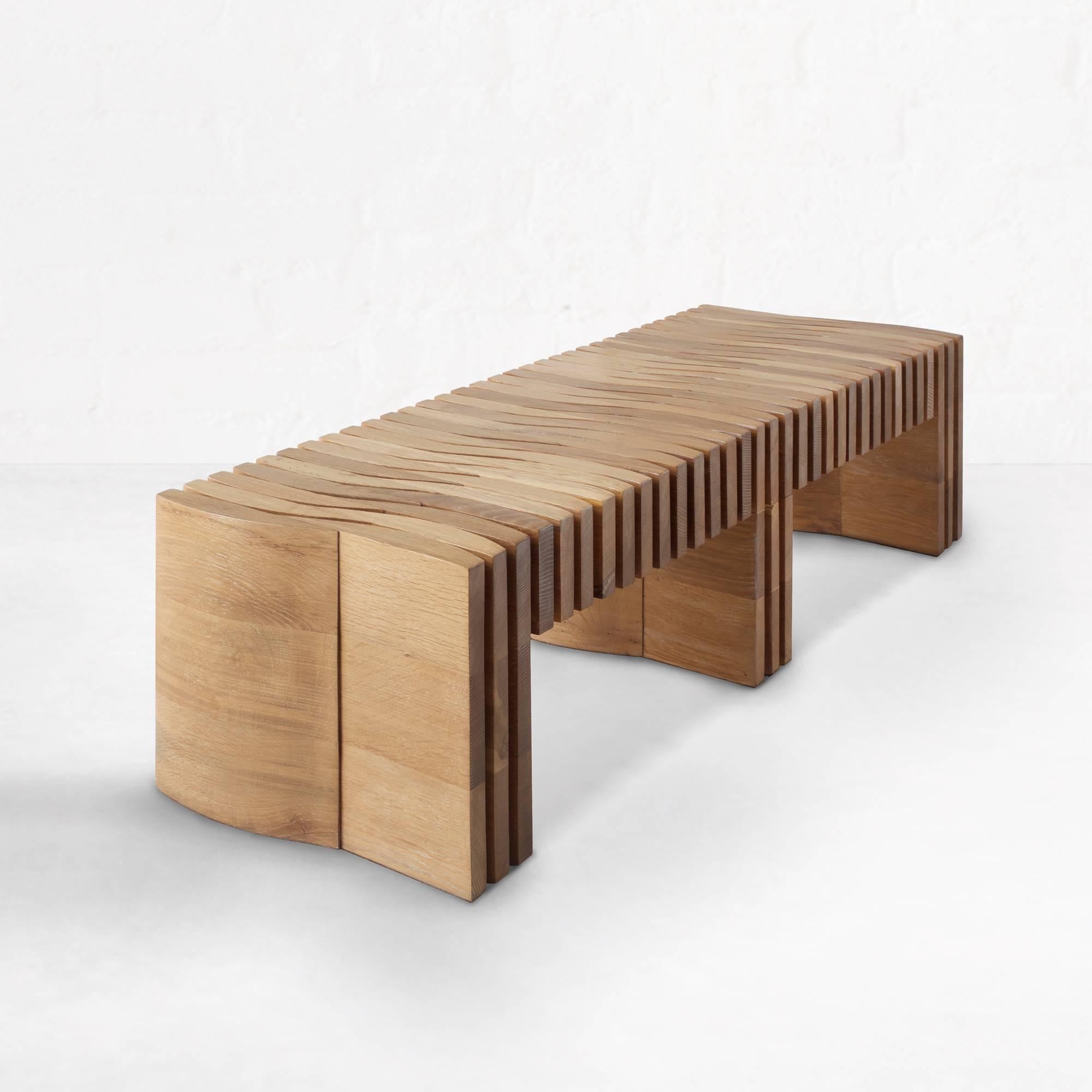 The Synthesis bench emphasizes light and shadow through its seamless composition of 136 individually cut and hand finished pieces of solid hardwood. No joints or hardware are exposed, giving its construction an air of mystery. It is cleverly