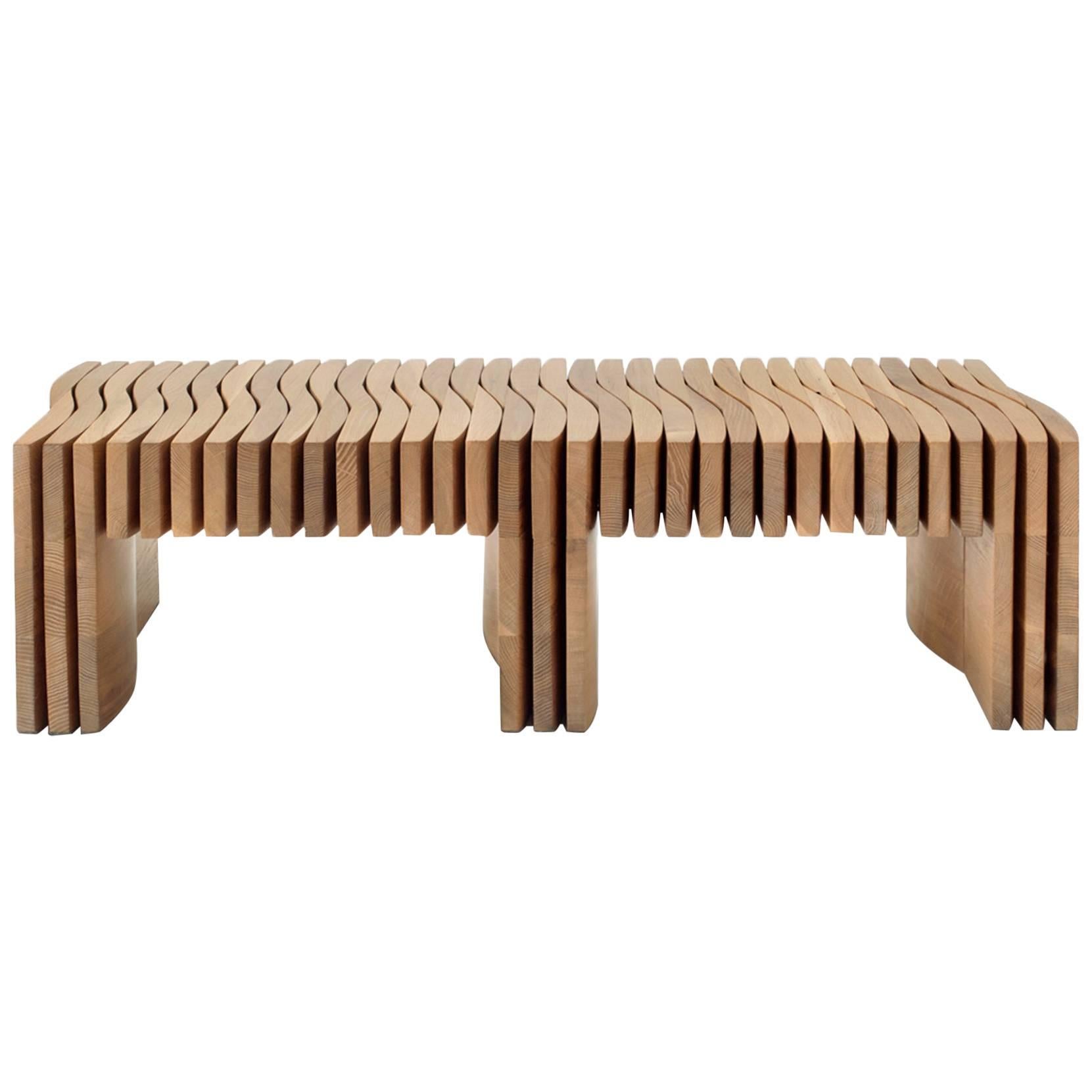 The synthesis bench emphasizes light and shadow through its seamless composition of 136 individually cut and hand finished pieces of solid hardwood. No joints or hardware are exposed, giving its construction an air of mystery. It is cleverly