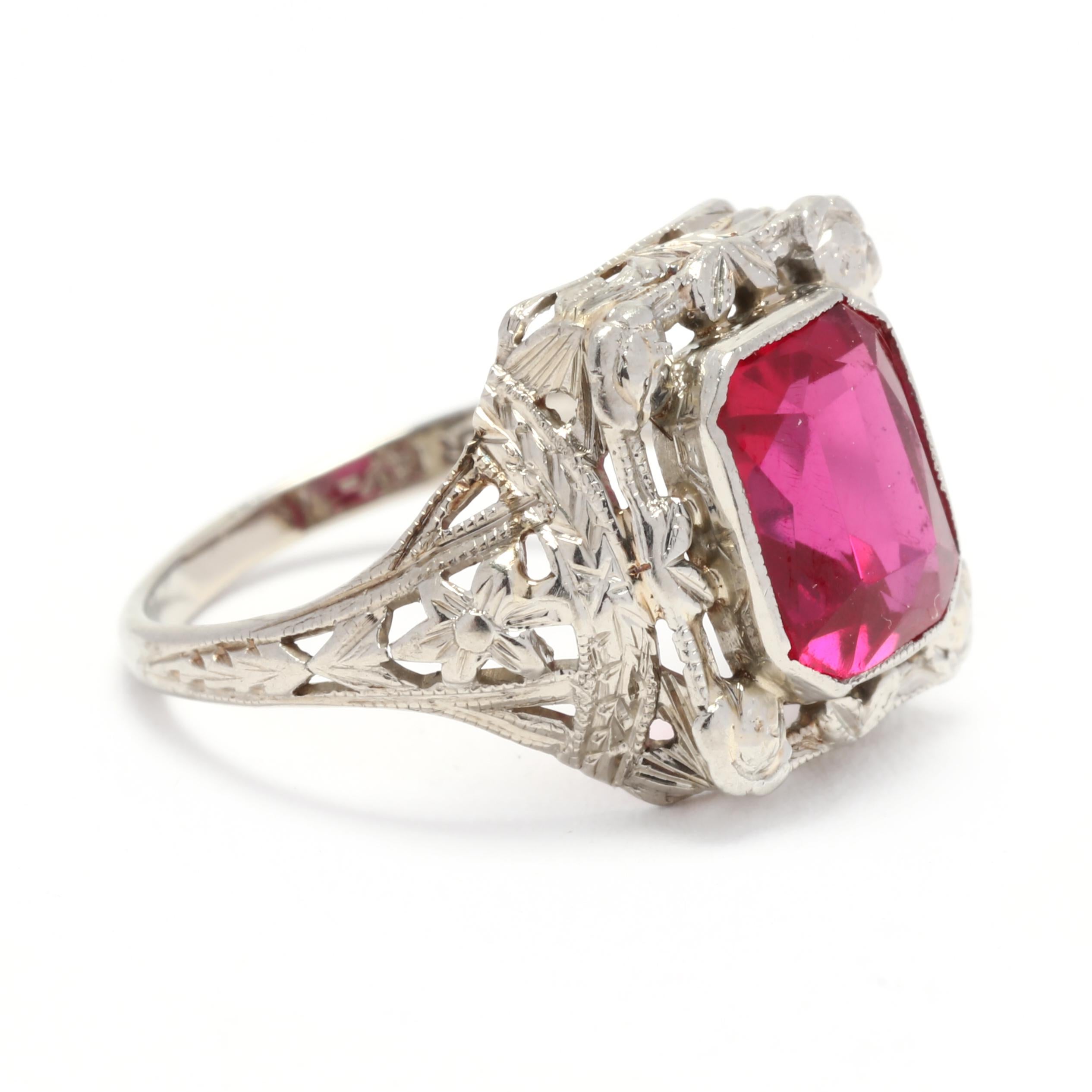 This stunning vintage synthetic ruby ring is a true statement piece that will surely turn heads. Crafted in 14K white gold, the ring features a 2-carat synthetic ruby as the centerpiece. The ruby is cut in a floral shape and surrounded by intricate