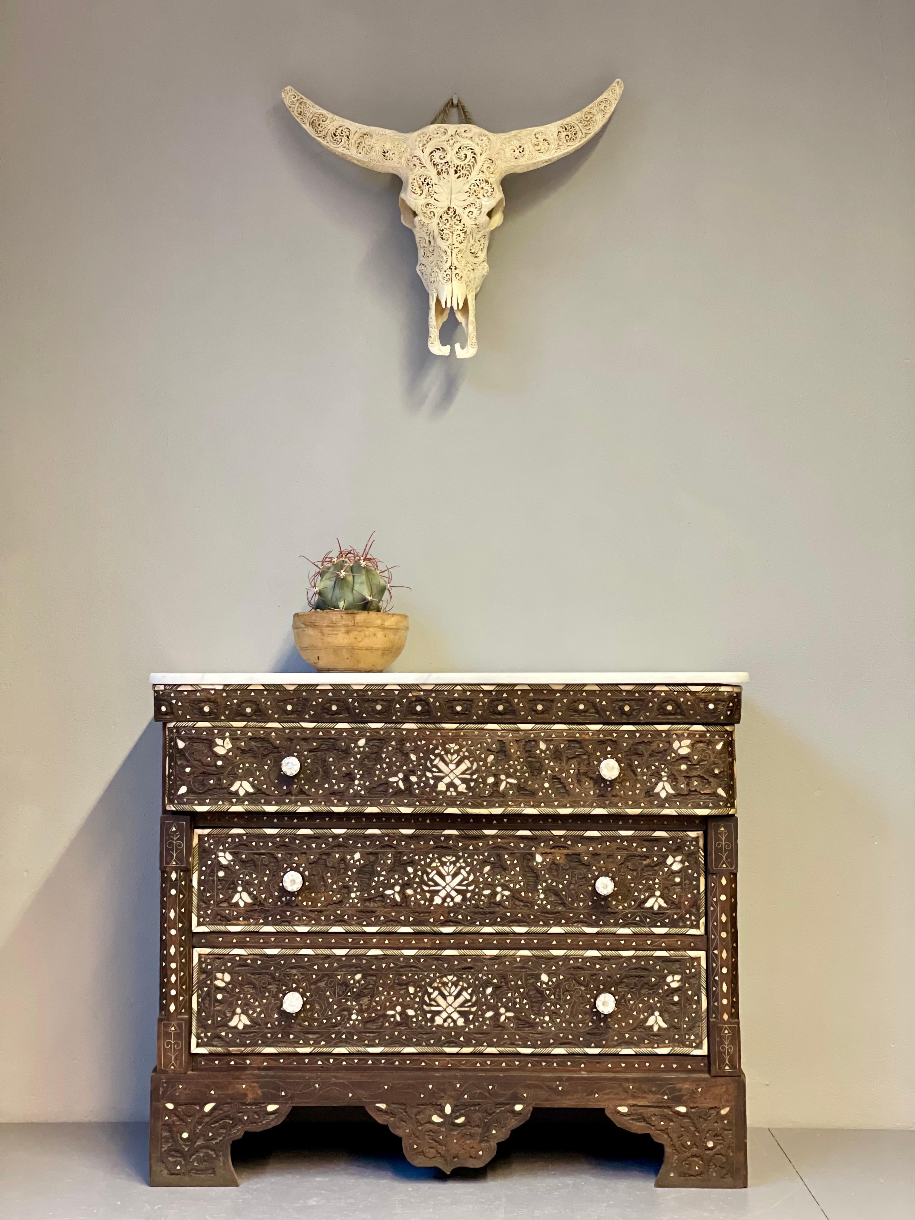 This handcrafted Syrian wedding chest is designed with mother-of-pearl inlays, three drawers and a marble top. It expresses the rich culture and artwork from where it stems.
Handcrafted with intricate Islamic and floral designs by a Moroccan