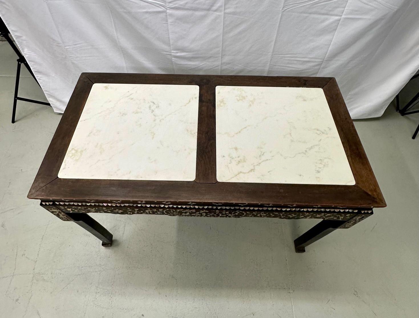Syrian Rosewood and Mother of Pearl Inlay Console Table with Marble Top
The fine table top having a thick marble top in two pieces supported by a fine mother of pearl inlay apron on long sleek legs. The apron design very bobo chic with birds,
