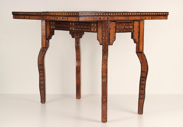A fine marquetry, micro mosaic inlayed games table made in Syria around the turn of the 19th and early 20th Century. Complete with felt card table, chess/drafts board and back gammon board with the swivel top rotating to reveal an open secrecy