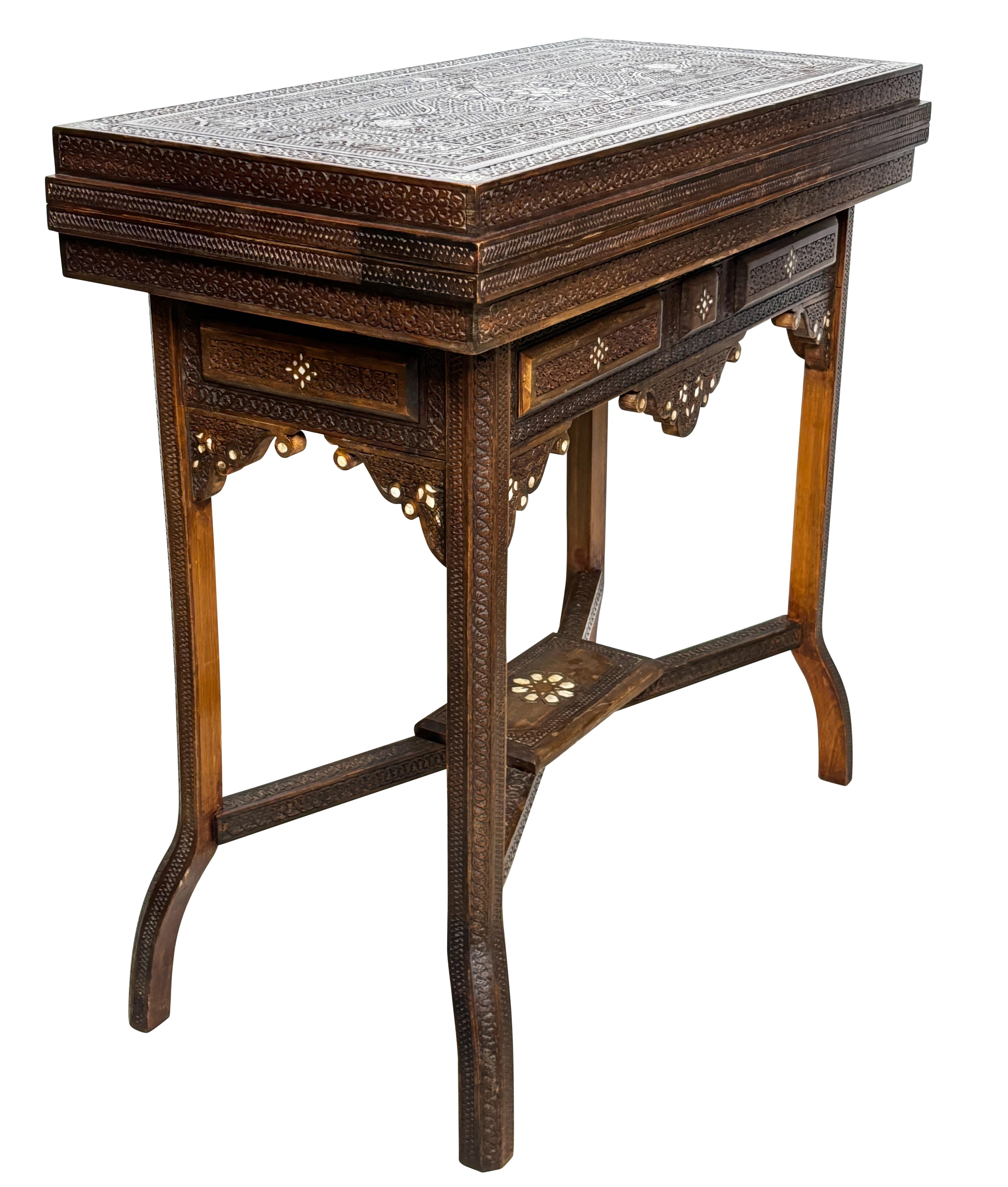 Syrian game table, extensively hand carved walnut, with inlay of bone and mother of pearl. Top opens and flips to show chess, checkers and backgammon boards. The top lifts off to reveal a green velvet lined compartment to hold game pieces. Table