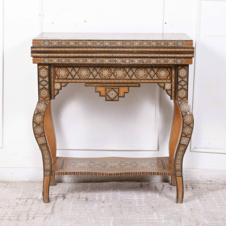 A fine early 20th century inlaid Syrian occasional table of rectangular form with an intricate geometric pattern, inlaid with mosaic bone, ebony, mother of pearl and other woods marquetry work throughout, having a shaped apron and raised upon square