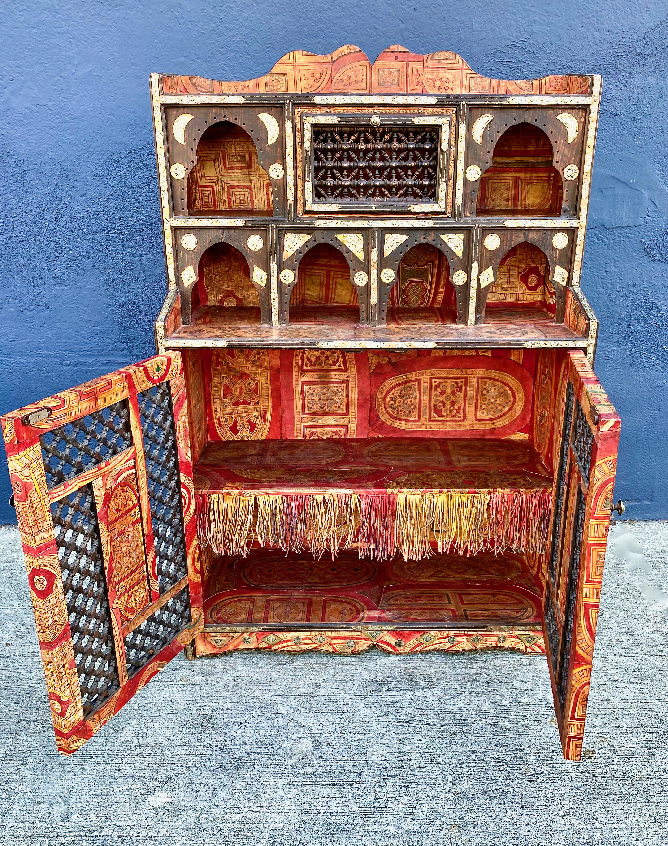 This is a wonderfully creative Levantine or Syrian cabinet that dates to the late 19th century. It's style is reminiscent of the work of Carlo Bugatti. This cabinet is intricately detailed in inlaid bone, metal, leather and lacquered paper; it even