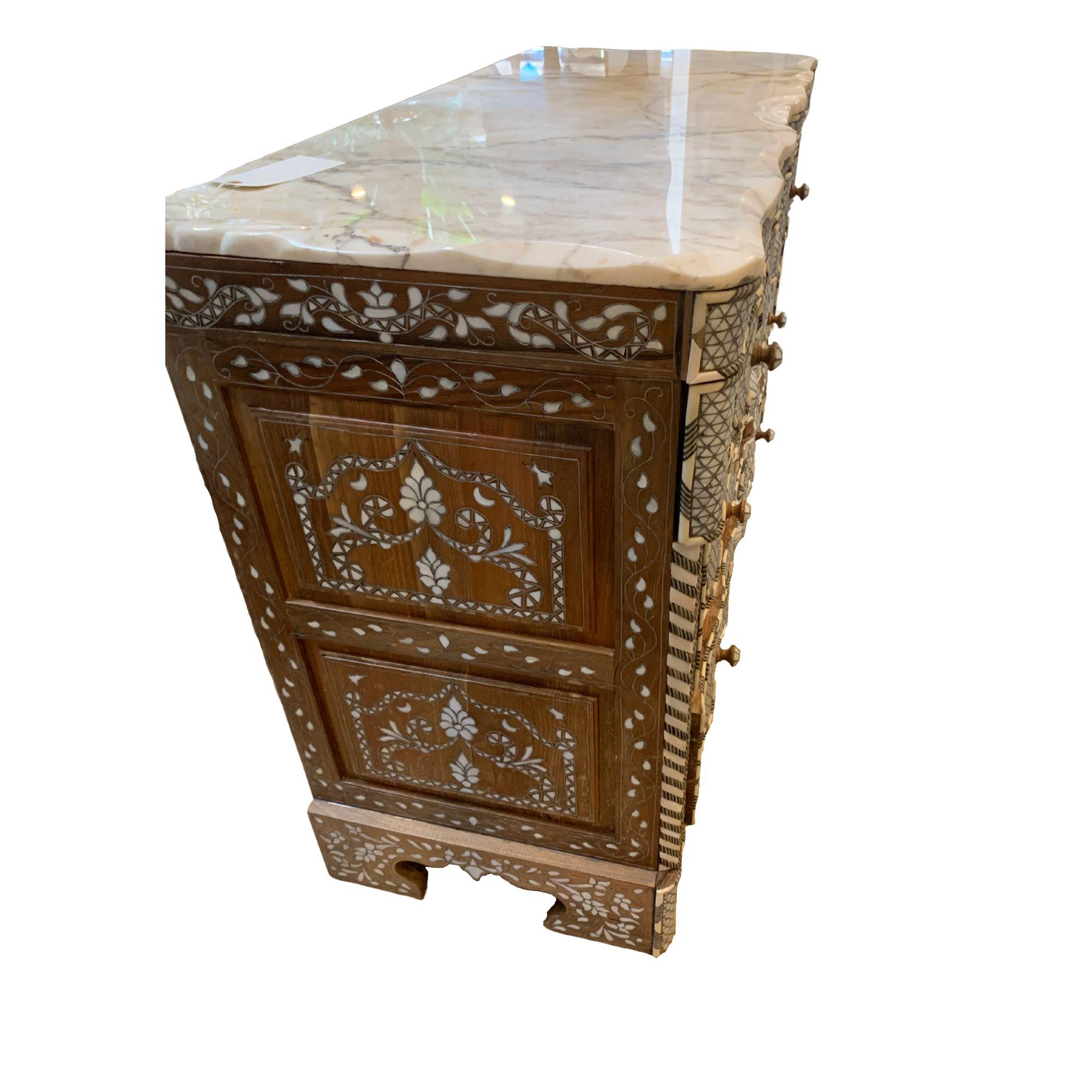 Syrian chest of drawers featuring mother of pearl inlay and topped with marble.