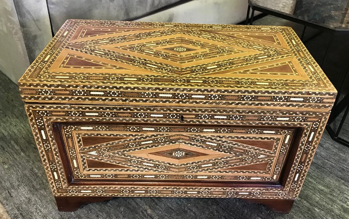 Stunning mosaic, geometrical design and gorgeous craftsmanship. The trunk is made of various wood, mother of pearl and bone inlays. A genuine work of art. 

Would stand out in any setting or home. 

Please note that at one time the piece may