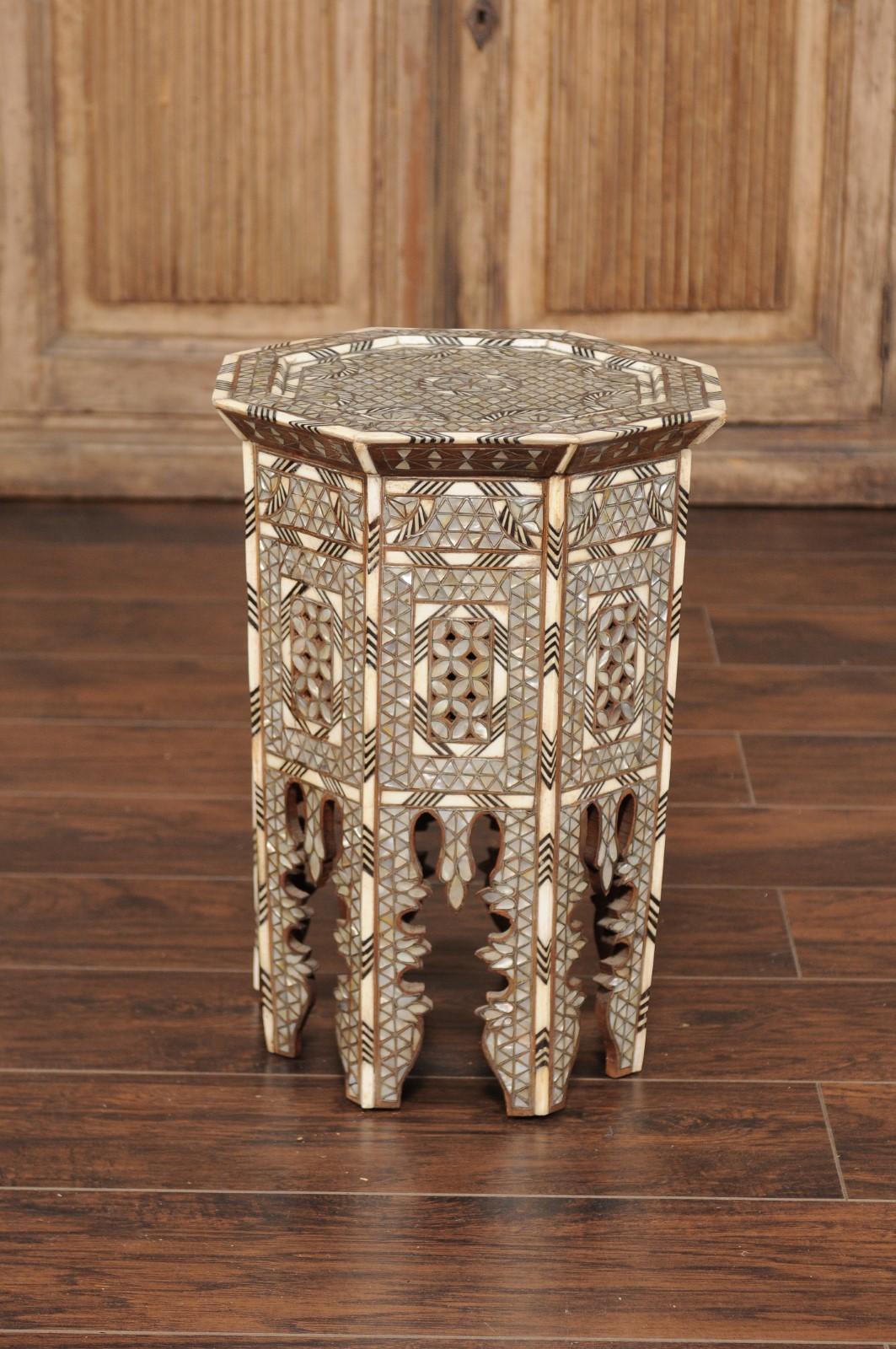 A Syrian hexagonal Moorish style side table with mother of pearl and bone inlay. Capturing our attention with its striking silhouette, this Moorish style side table features an exquisite décor, where no area is left untouched, evoking the 