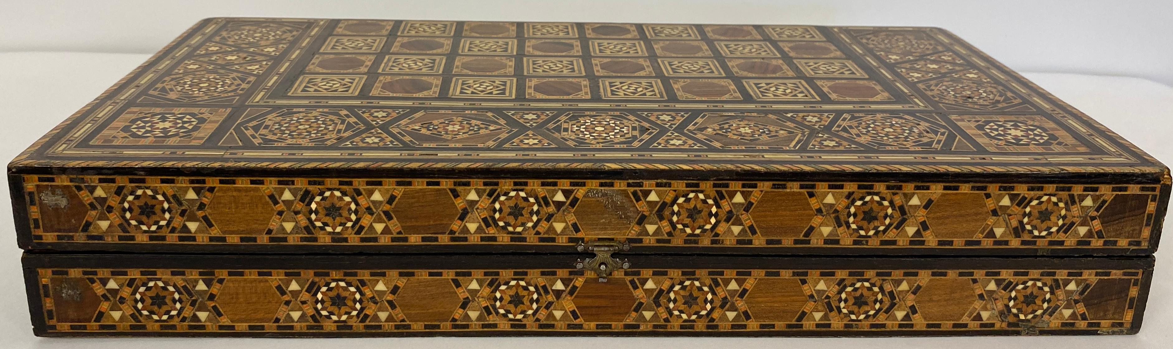 Stunning mosaic Backgammon set featuring a traditional Syrian style design and fine craftsmanship. The board/ box is made of various woods, mother-of-pearl, and bone inlays. A genuine work of art. A set of backgammon pieces are included (possibly