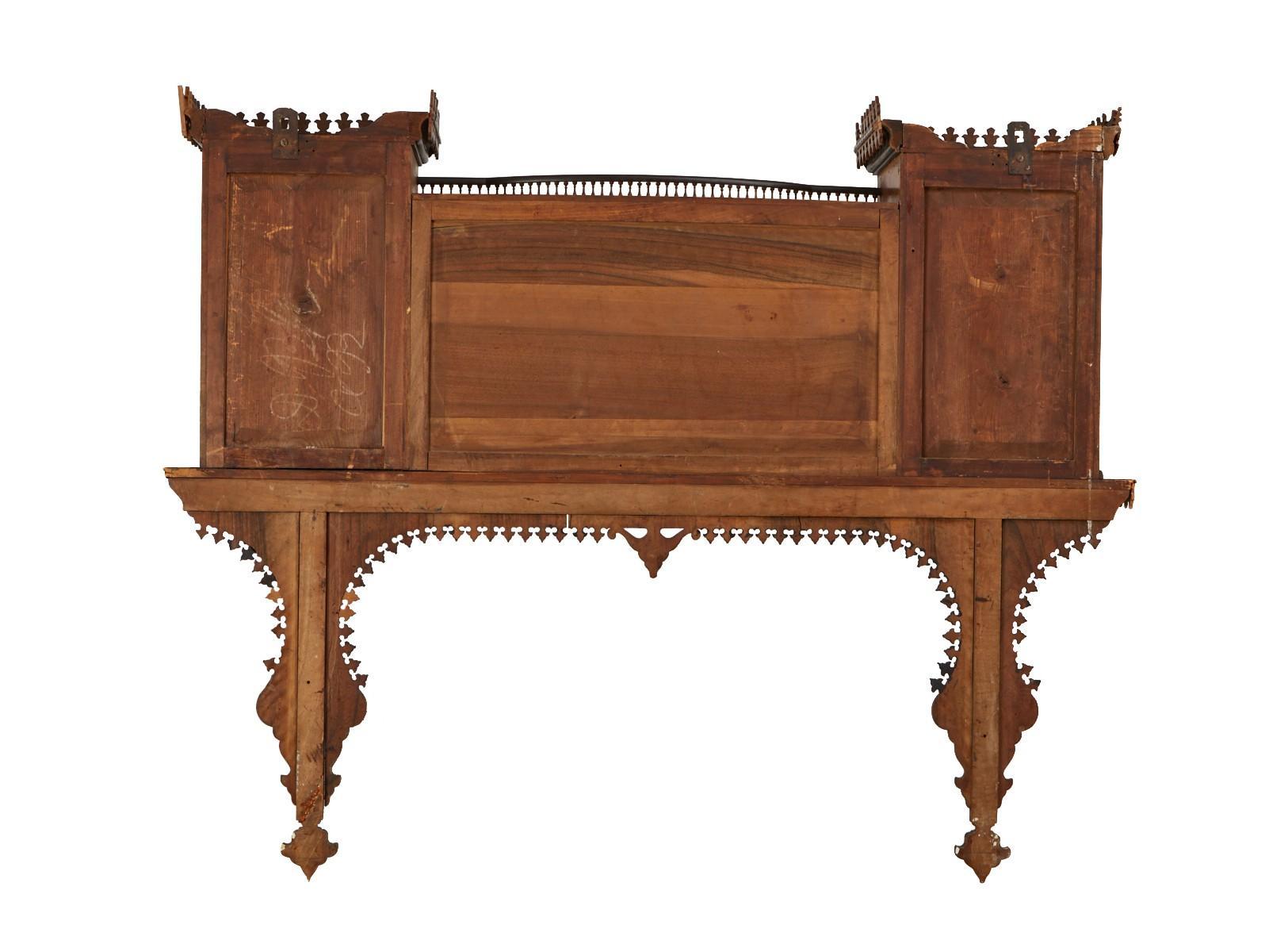 19th Century wall cabinet with architectural inspired form having intricate marquetry inlay in walnut with contrasting wood mother of pearl and ebonized wood. The upper tier fine pierced fret gallery and bracket supports on either side. The parapet
