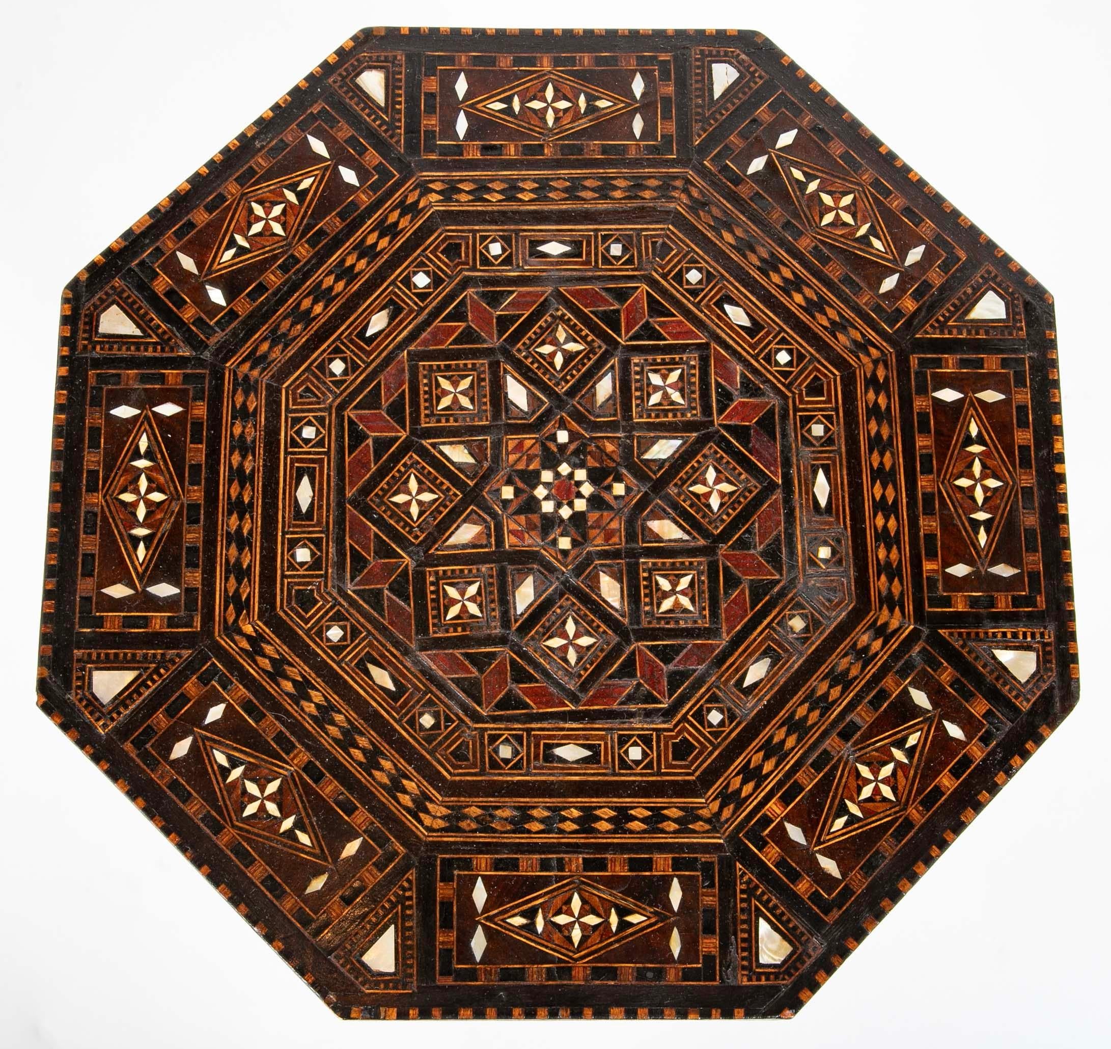 Syrian octagonal side with inlay of mother-of-pearl ebony, rosewood, and various fruit woods. Best quality, with intricate geometric inlay over the surface and sides. With a beautiful silhouette, this will make a singular drinks table. 
Stamped