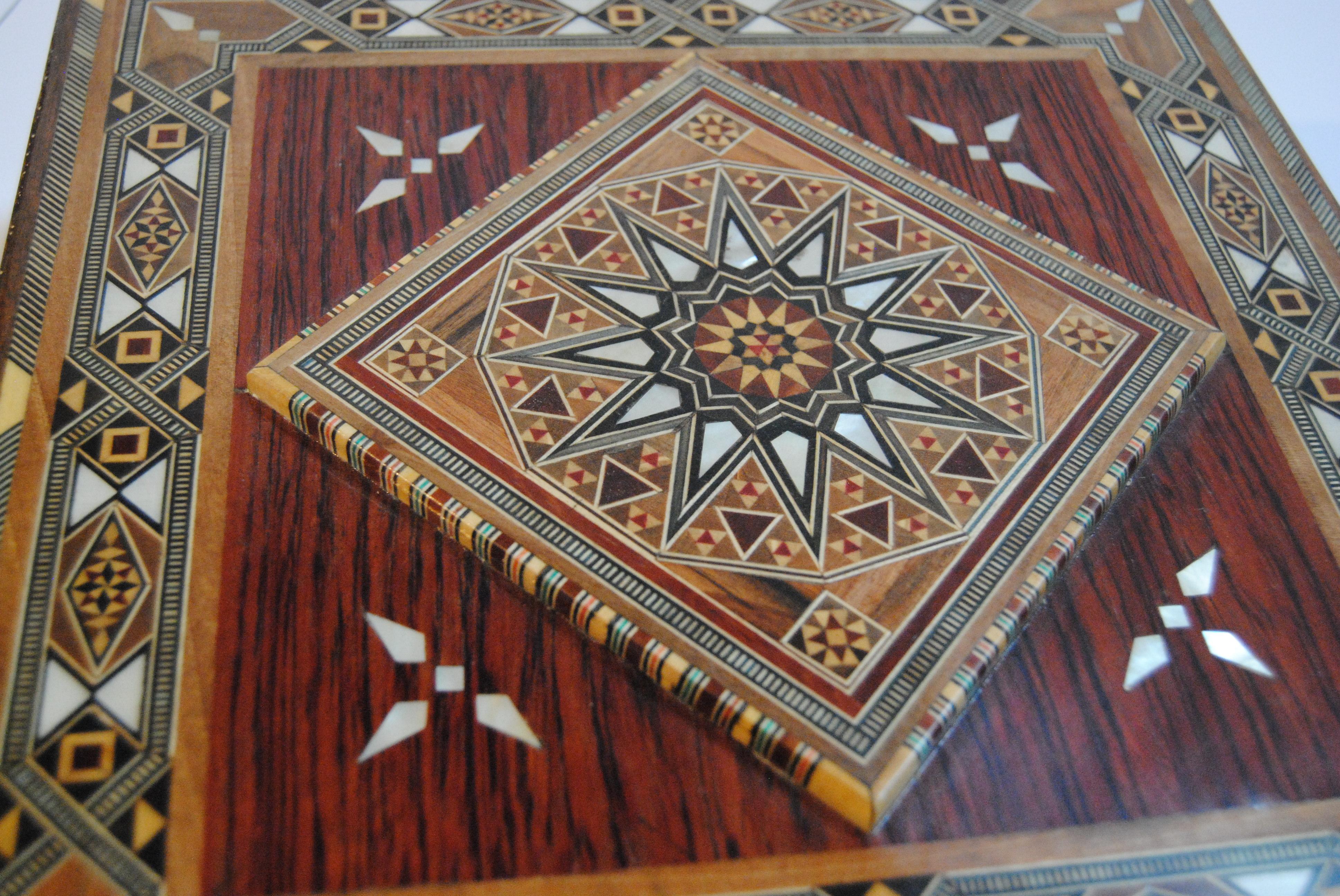 Syrian walnut wood box with fruitwoods and mother of pearl. The box has a raised center diamond design with very intricate inlay. It is lined with cream leather. Handmade by skilled Syrian craftsmen from Damascus in the late 20th century. In new