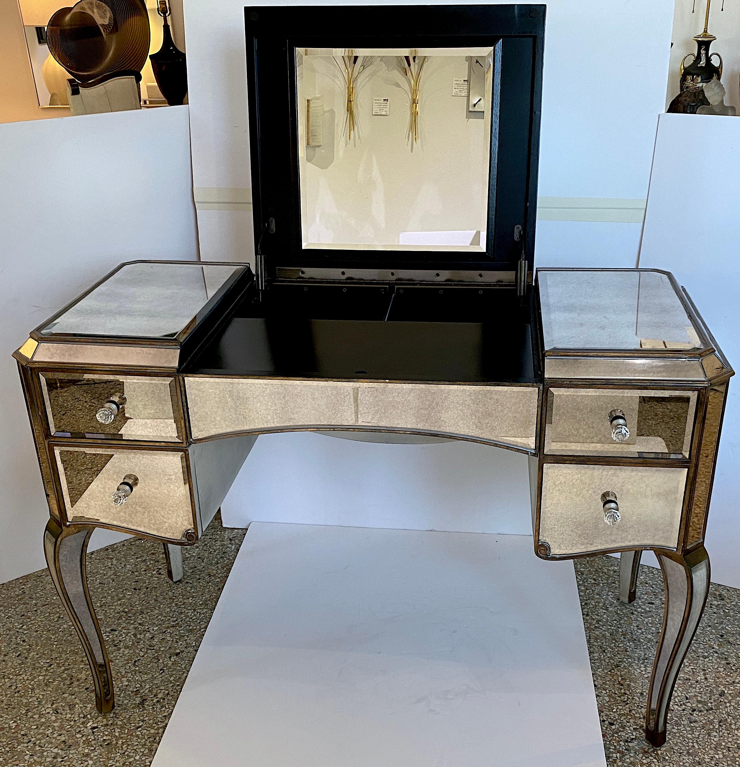 This stylish mirrored vanity table is very much in the manner of pieces created by the designer Syrie Maugham. 

Note: When opened up the overall height is 48