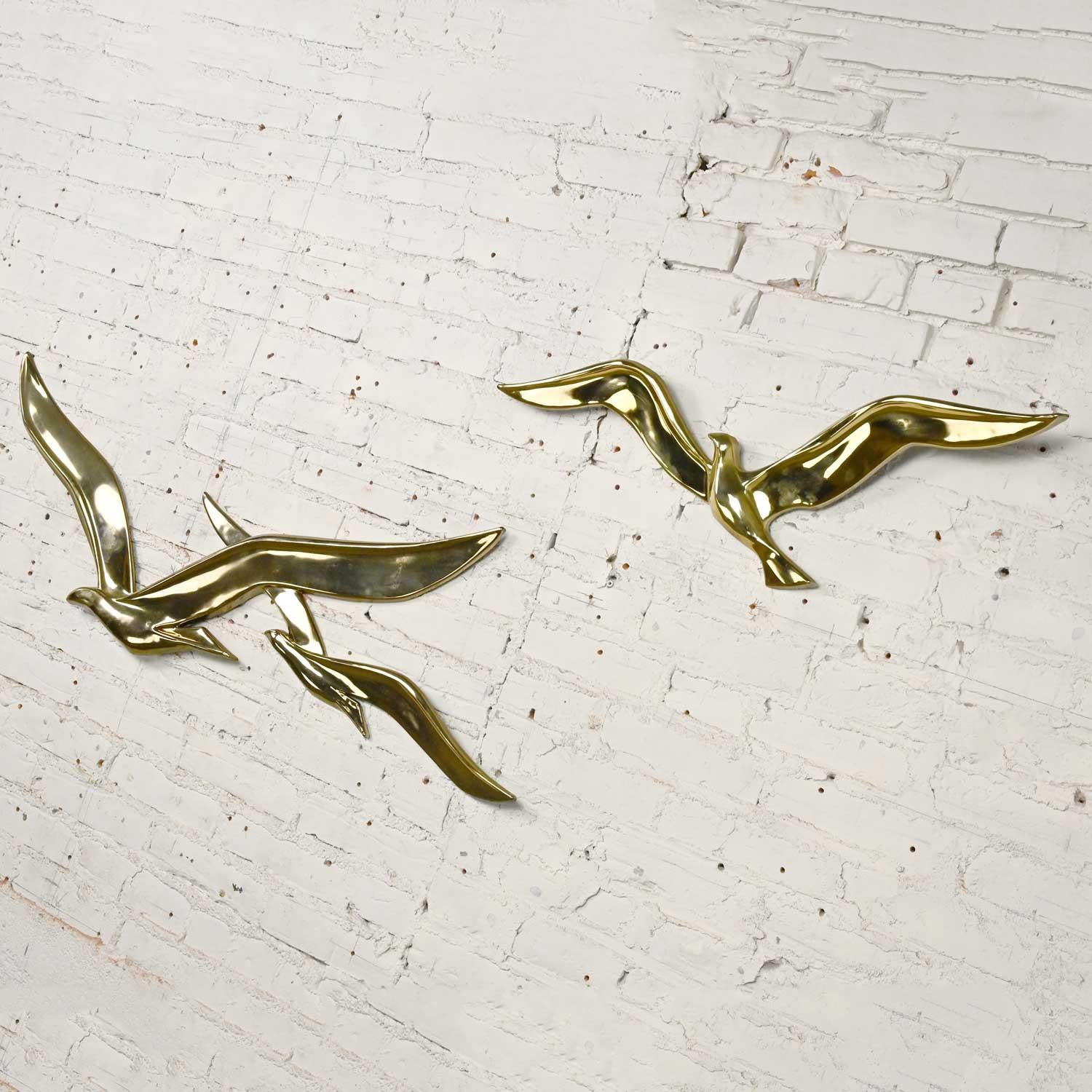 Fabulous vintage mid-century modern gilded plastic seagulls in flight birds 2-piece wall sculpture by Syroco. Beautiful condition, keeping in mind that these are vintage and not new so will have signs of use and wear. The gold has rubbed off in a