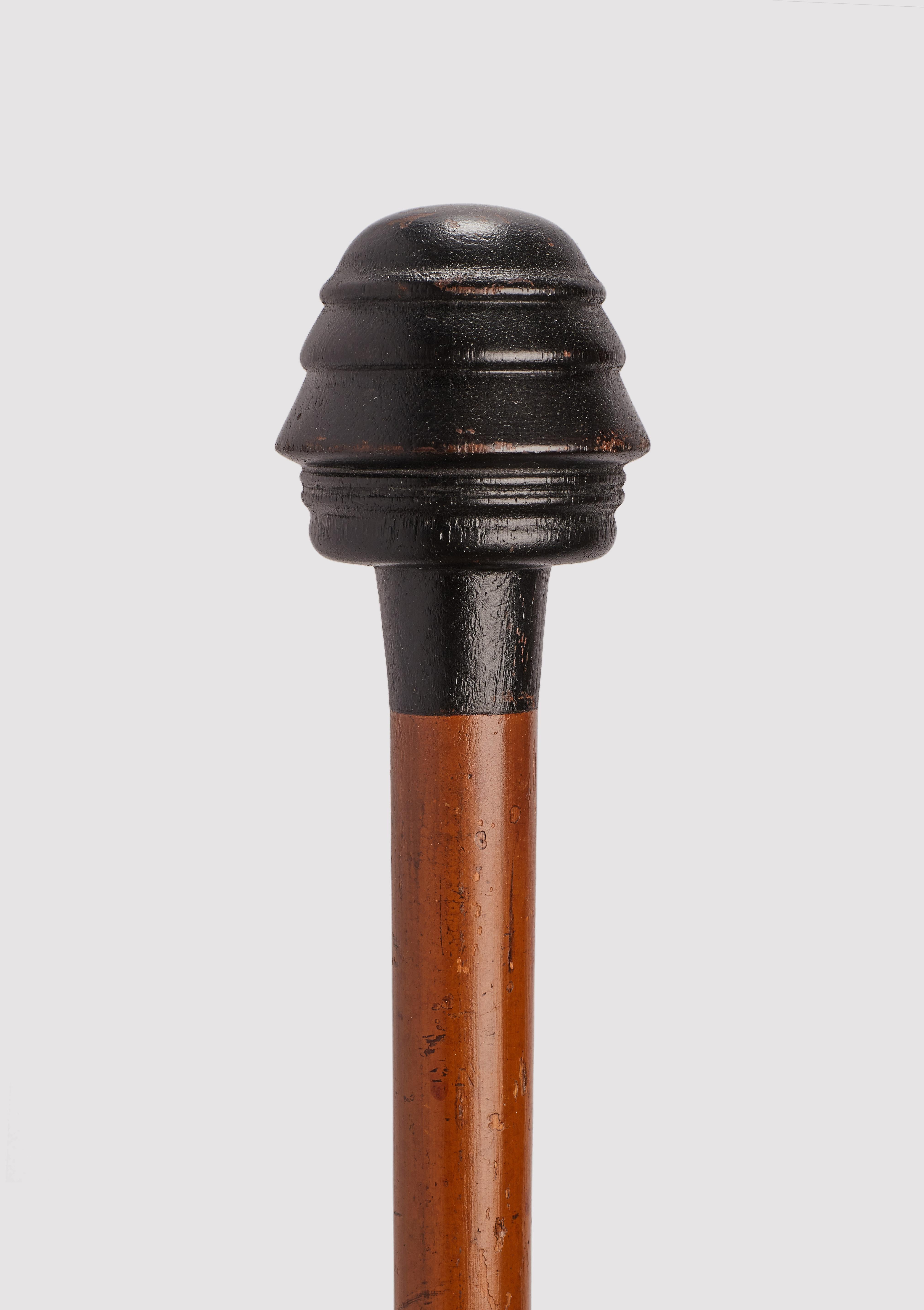 Gadget-System walking stick: shadow gadget cane with Napoleon profile on its ebonized wood handle. Malacca wood shaft. Iron ferrule. France 1870 circa.