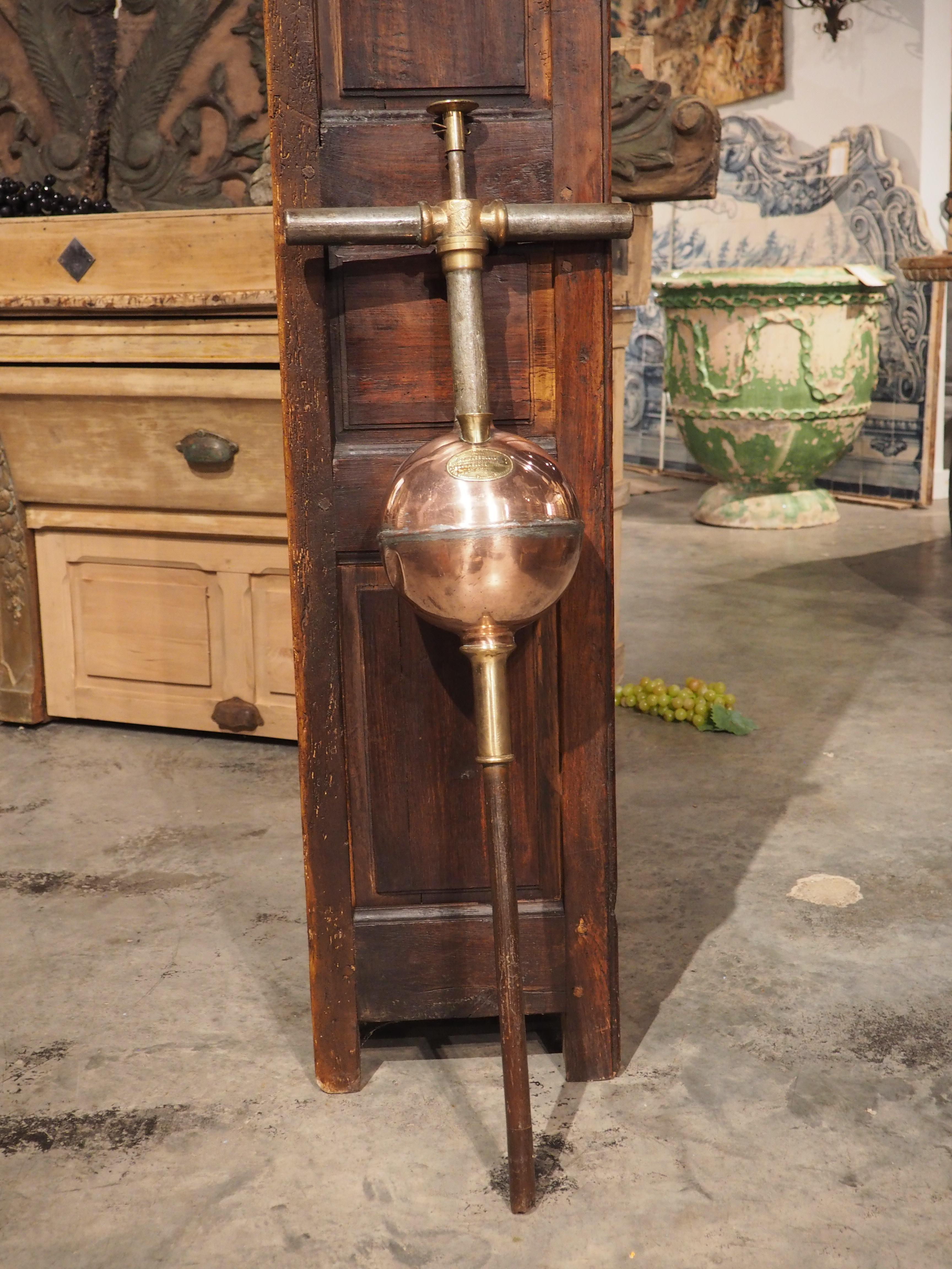 Used at a French vineyard to prevent phylloxera infestation of grapevines (the insect almost wiped out French vineyards in the late 1800’s), this copper vine root injector was crafted in Marseille, France. The large copper vessel has a brass intake