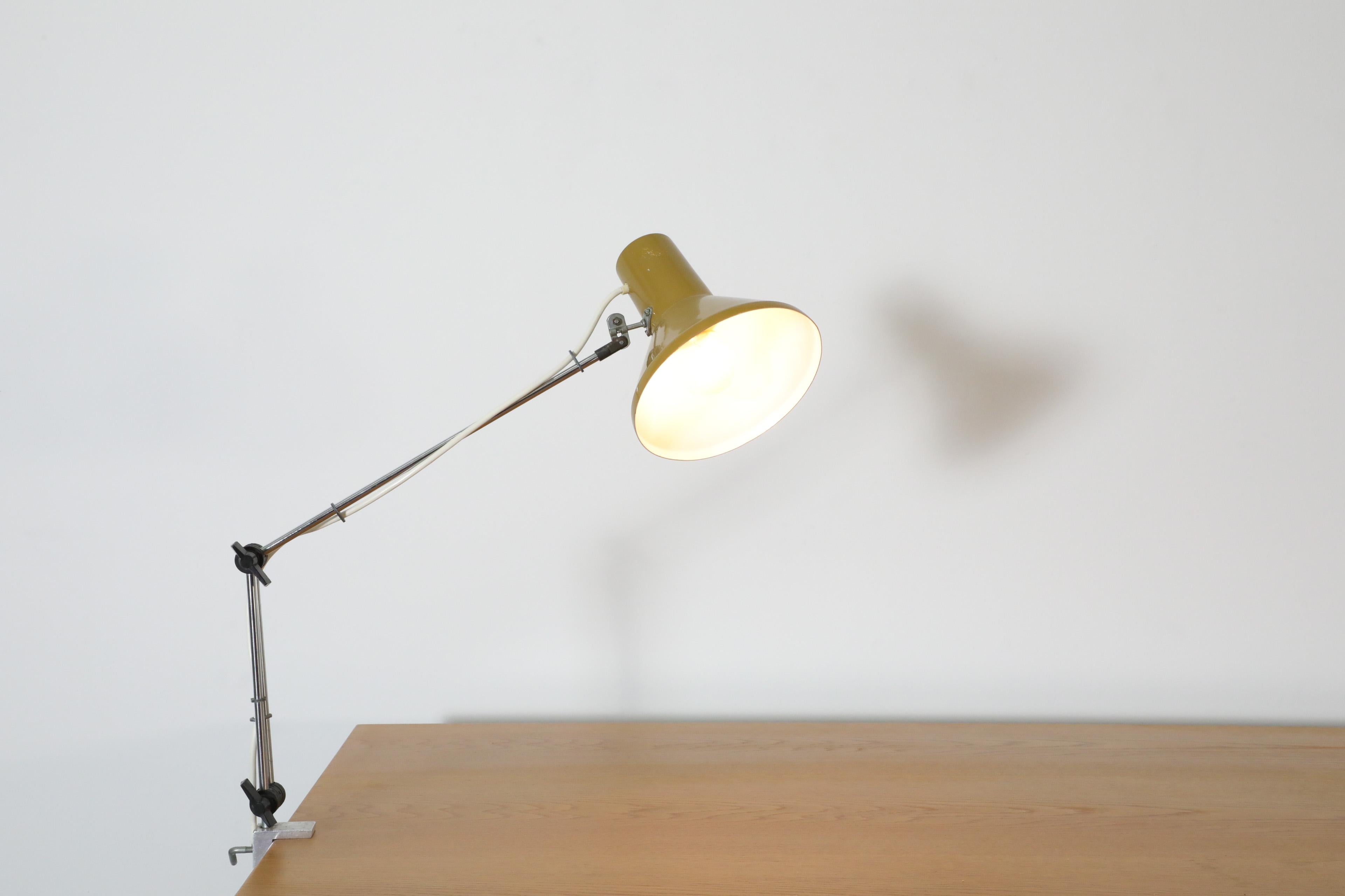Mid-Century Hungarian industrial clamp on table lamp with olive enameled metal shade, chrome hardware and a solid aluminum clamp. In original condition with visiblewear and scratching consistent with age and use. Other clamp-on drafting lamps are