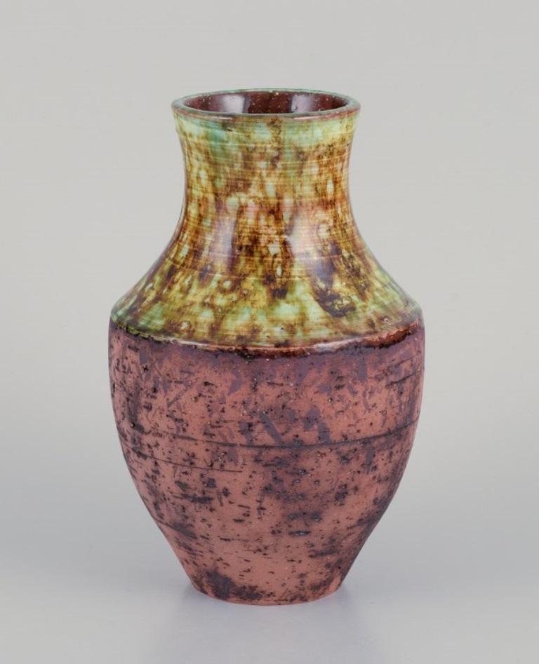 Szilasi, Visby, Sweden. Unique ceramic bowl and vase. 
Glazed in green-brown tones.
Ca. 1960.
Incised signature.
In perfect condition.
Bowl: Diameter 14.0 cm x Height 7.5 cm.
Vase: Height 17.0 cm x Diameter 11.0 cm.
