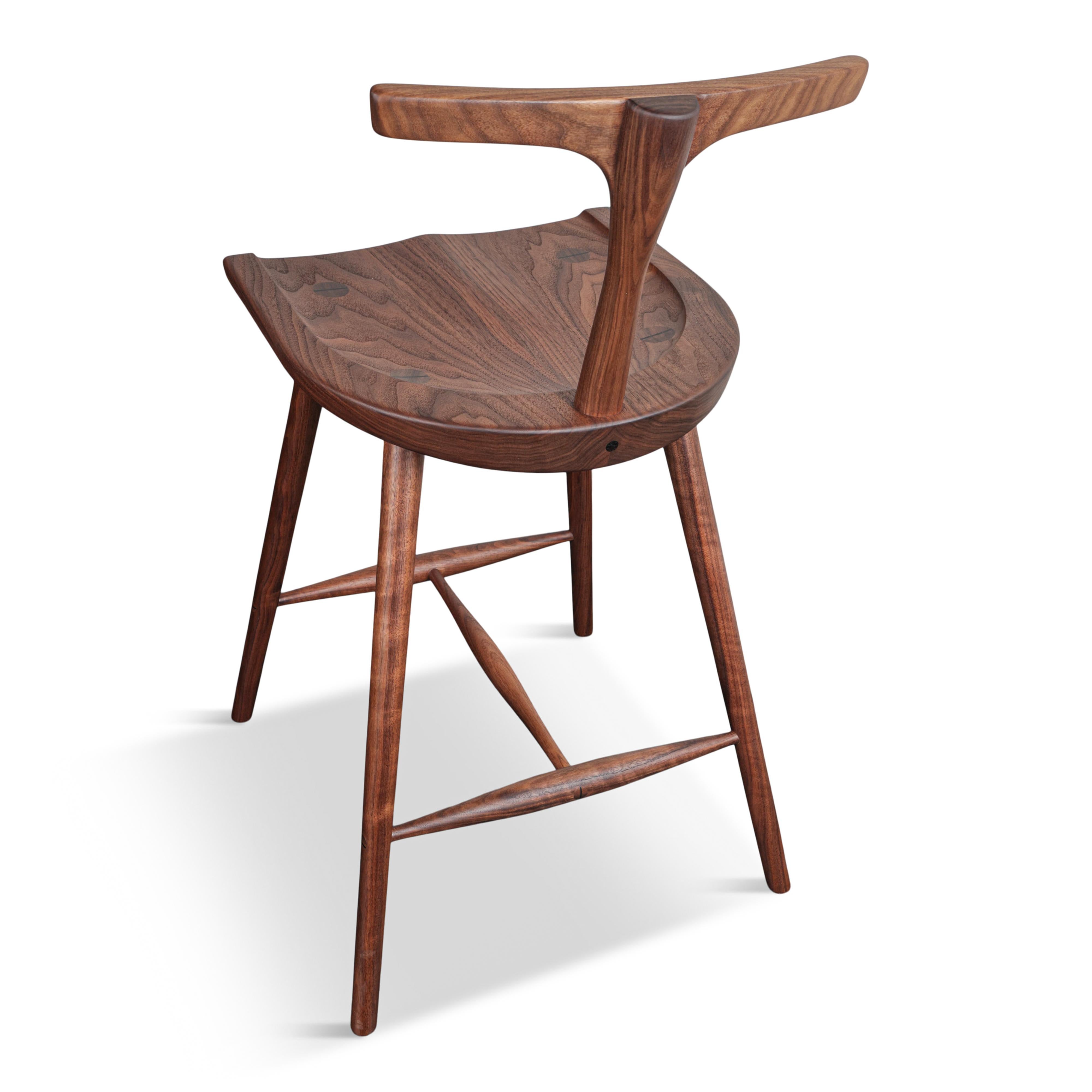 Comfortable, elegant and classic, a design that will beautifully suit any home interior. Handcrafted from solid American Black Walnut, made in Canada. The Krane stool features a generously sized, ergonomically sculpted seat with a perfectly sculpted