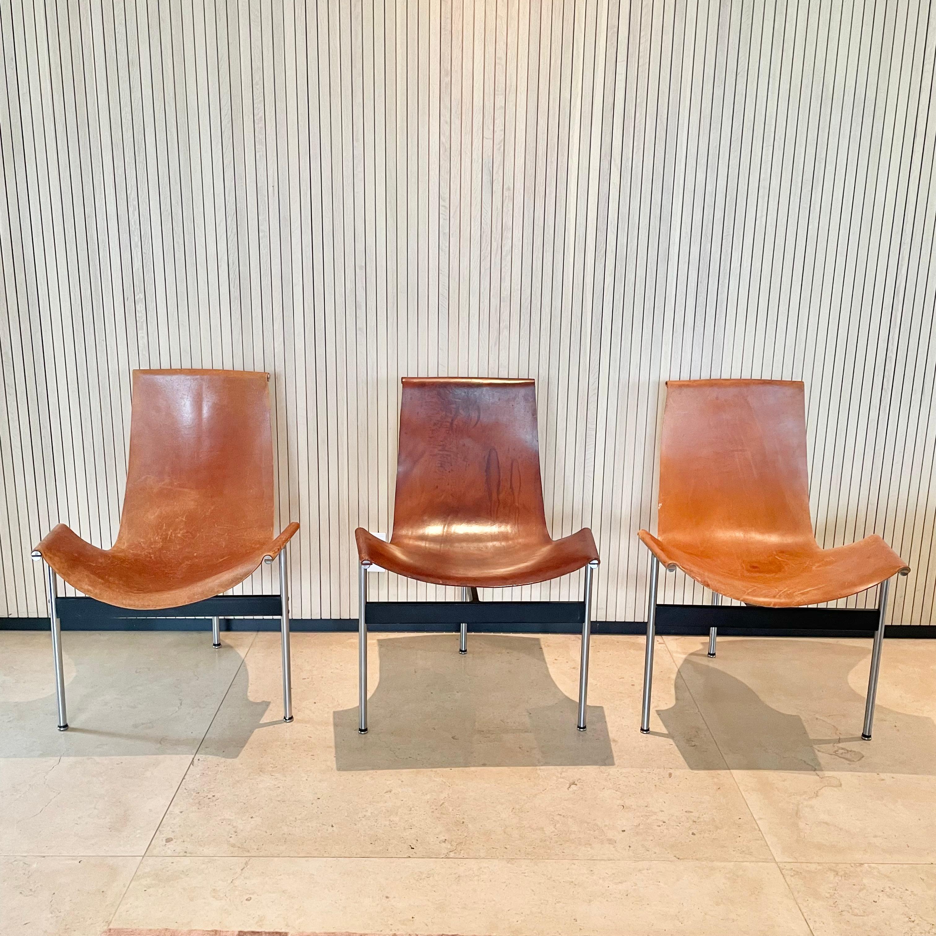 T chairs by Katavolos in original tan cowhide. Floating leather sling seat attached to the metal frame at 3 points by T bars. Great condition to chrome and leather. Priced individually.