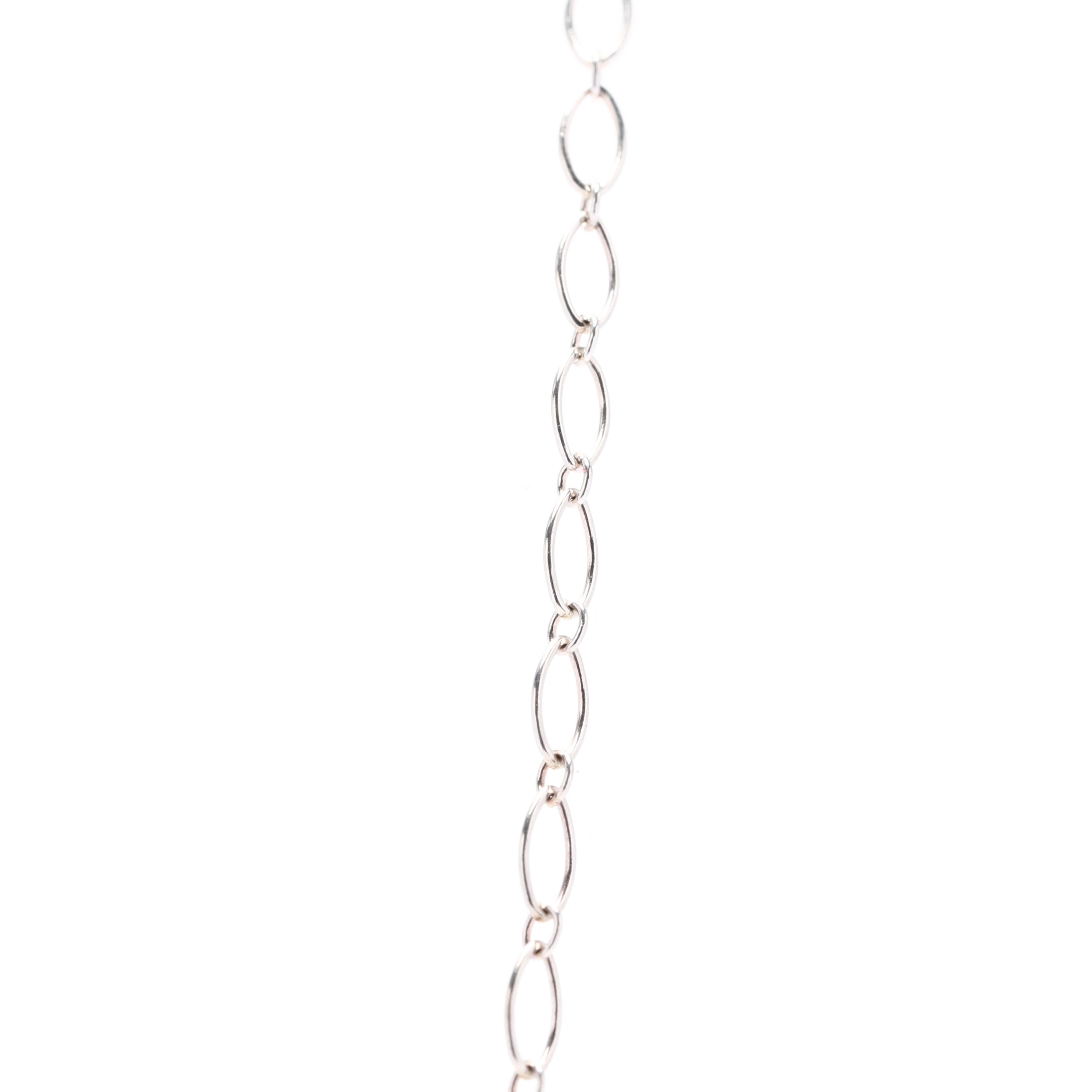 A sterling silver marquise link long chain by Tiffany and Company. This chain features an alternating design of marquise and oval linkts with a spring ring clasp.



Length: 30 in.



Width: 2.75 mm



Weight: 3 grams