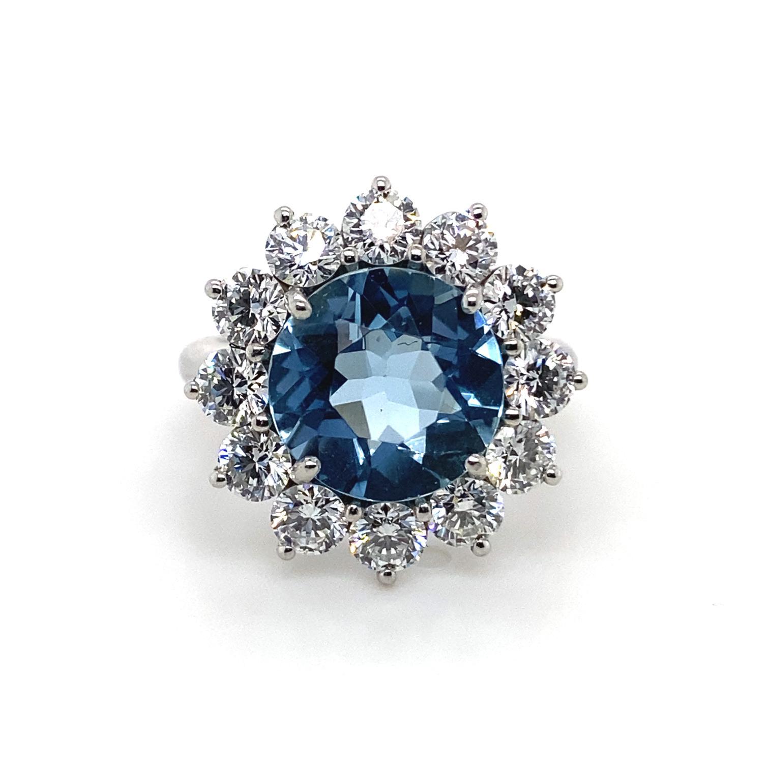 A T. Foster & Co aquamarine and diamond cluster platinum engagement ring.

This piece is centrally set with a 2.28ct round cut aquamarine, surrounded by a cluster of 12 round brilliant cut diamonds totalling 1.44cts assessed as H/I colour, VS1
