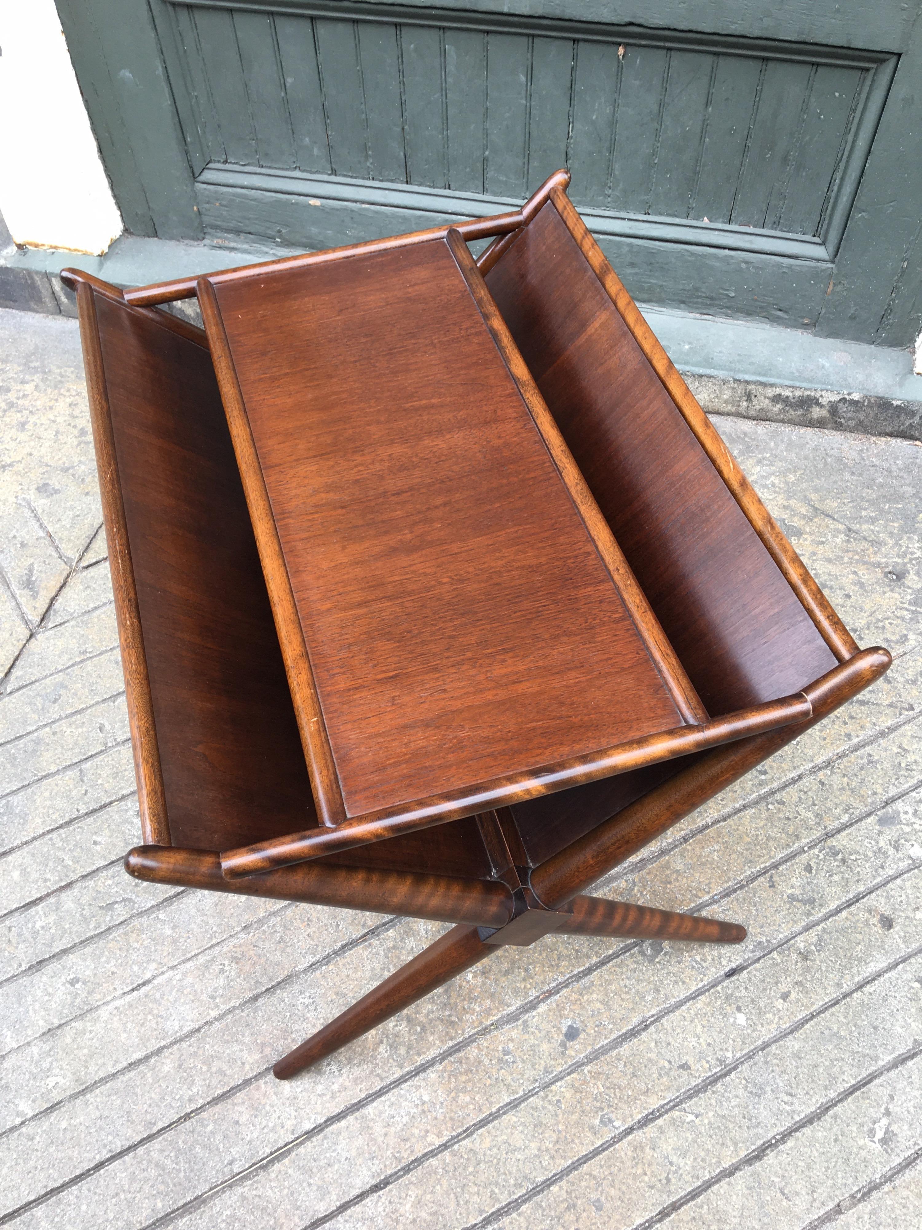 Versatile designed magazine table by T.H. Robbsjohn Gibbings for Widdicomb Furnture. Two angled panels allow for magazines and newspapers to be stored on sides with an ample top surface for a lamp. Very clean walnut finish, looks like it has been