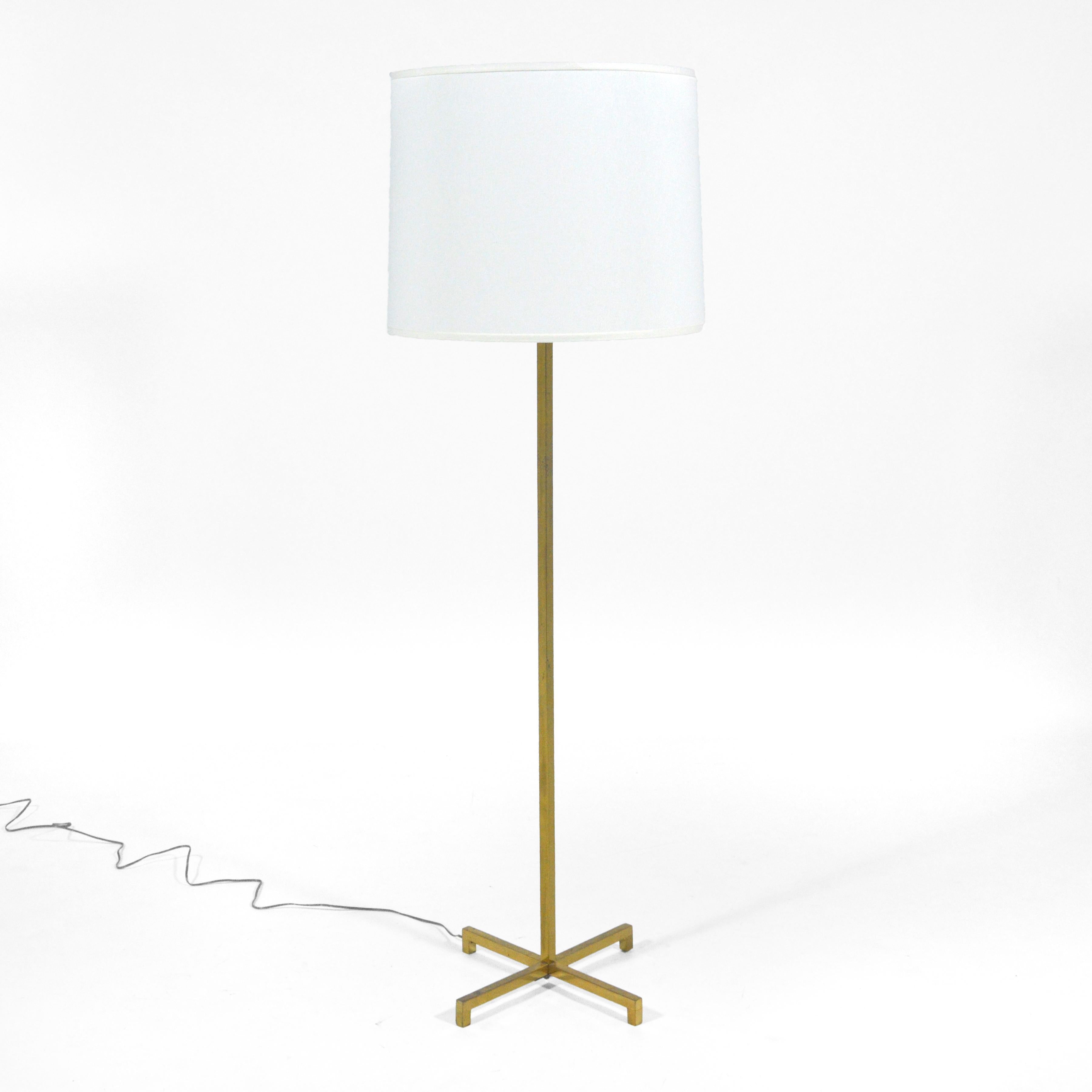 This beautiful brass floor lamp designed by T.H. Robsjohn-Gibbings for Hansen is classic Gibbings– understated, refined, exquisitely detailed and timeless. The cruciform base supports the square central column which has an adjustable three-bulb head