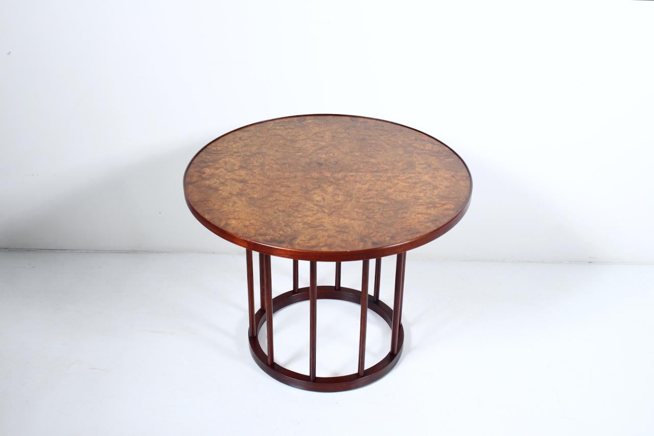 T.H. Robsjohn-Gibbings for Widdicomb Furniture Co. Burled Elm and Walnut Round Barrel Table. Featuring a Walnut lipped Carpathian Elm veneer circular surface with 10 spindles a top a balanced four footed Walnut 16.5D ring base. Versatile. Classic.